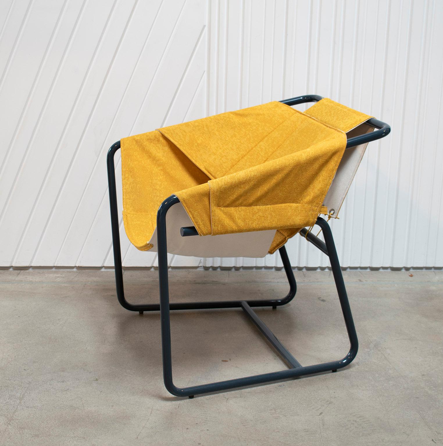 The easy chair combines the casual vibe of sling chairs with the cozy comfort of a classic club chair all in a floating form reminiscent of midcentury shell chairs. The top layer of the quilted sling is available in a choice of upholstery fabrics