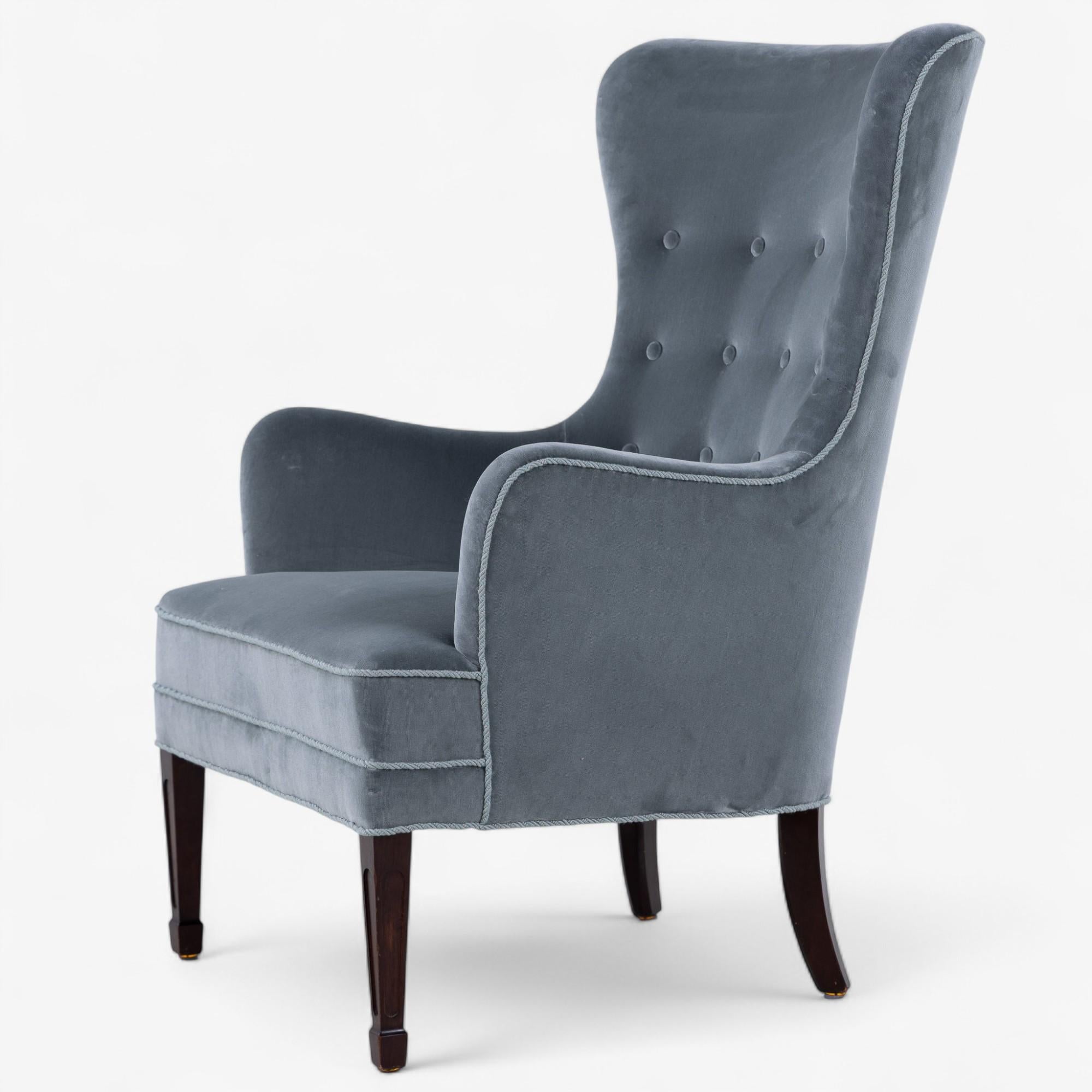Reupholstered easy chair in 'Forenza' fabric (colour: Rosemary) and dark stained wooden legs. 1940's by Frits Henningsen.