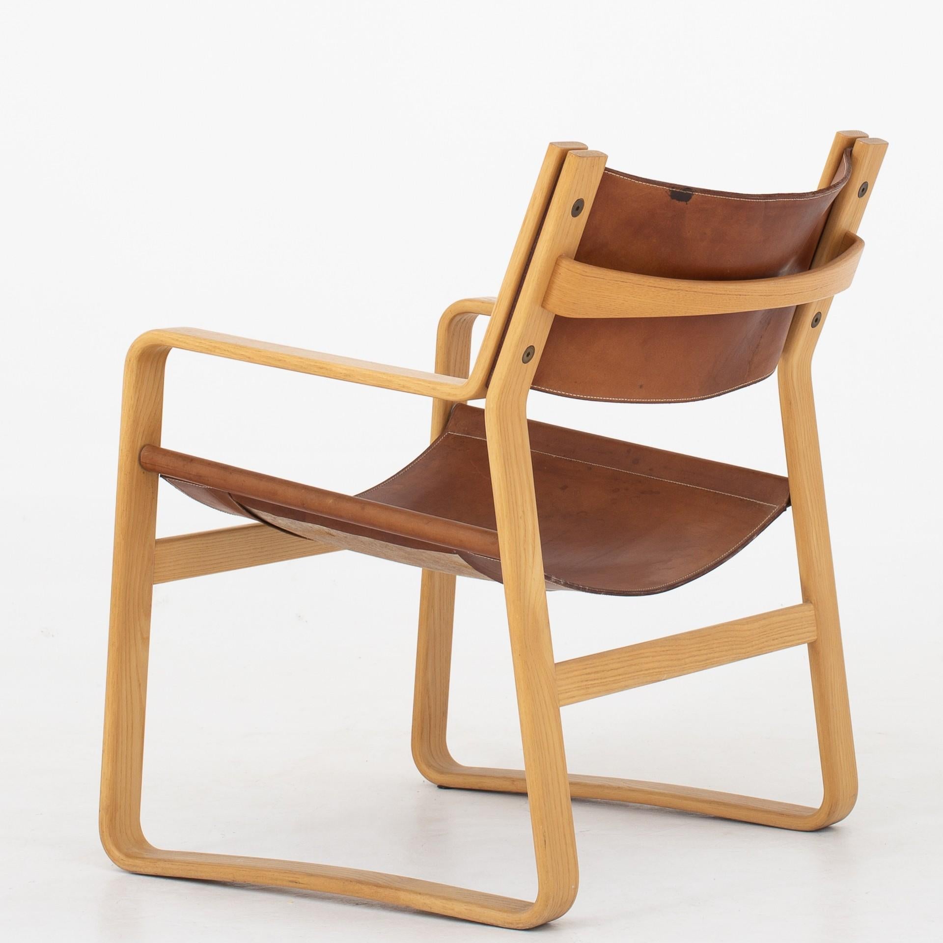 Easy chair in ash with original, patinated natural leather. 4 chairs in stock. Maker Johannes Hansen.