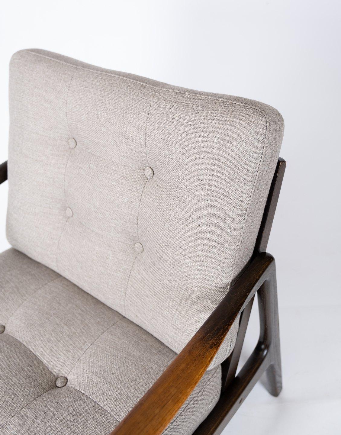 
This elegant easy chair, crafted from teak and expertly reupholstered in soft grey wool, is a stunning example of mid-century Scandinavian design. Designed by the acclaimed Danish designer Kai Kristiansen in the 1960s, this chair embodies the