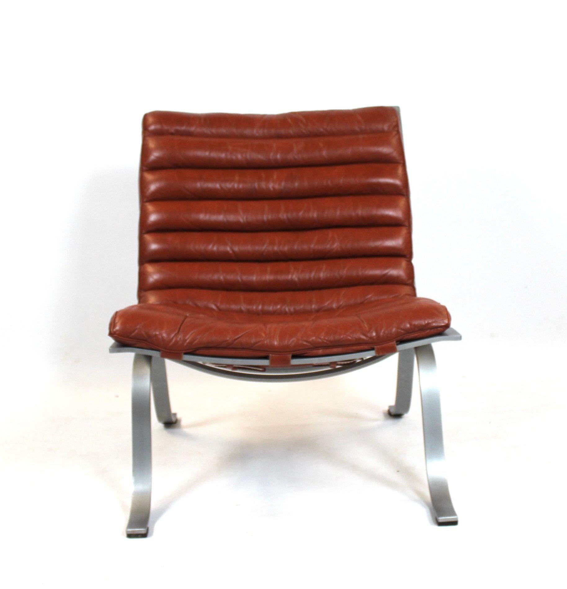 Easy chair, model Ariet, of red leather and steel frame designed by Arne Norell and manufactured by Norell Furniture AB. The chair is in great vintage conditon.
  