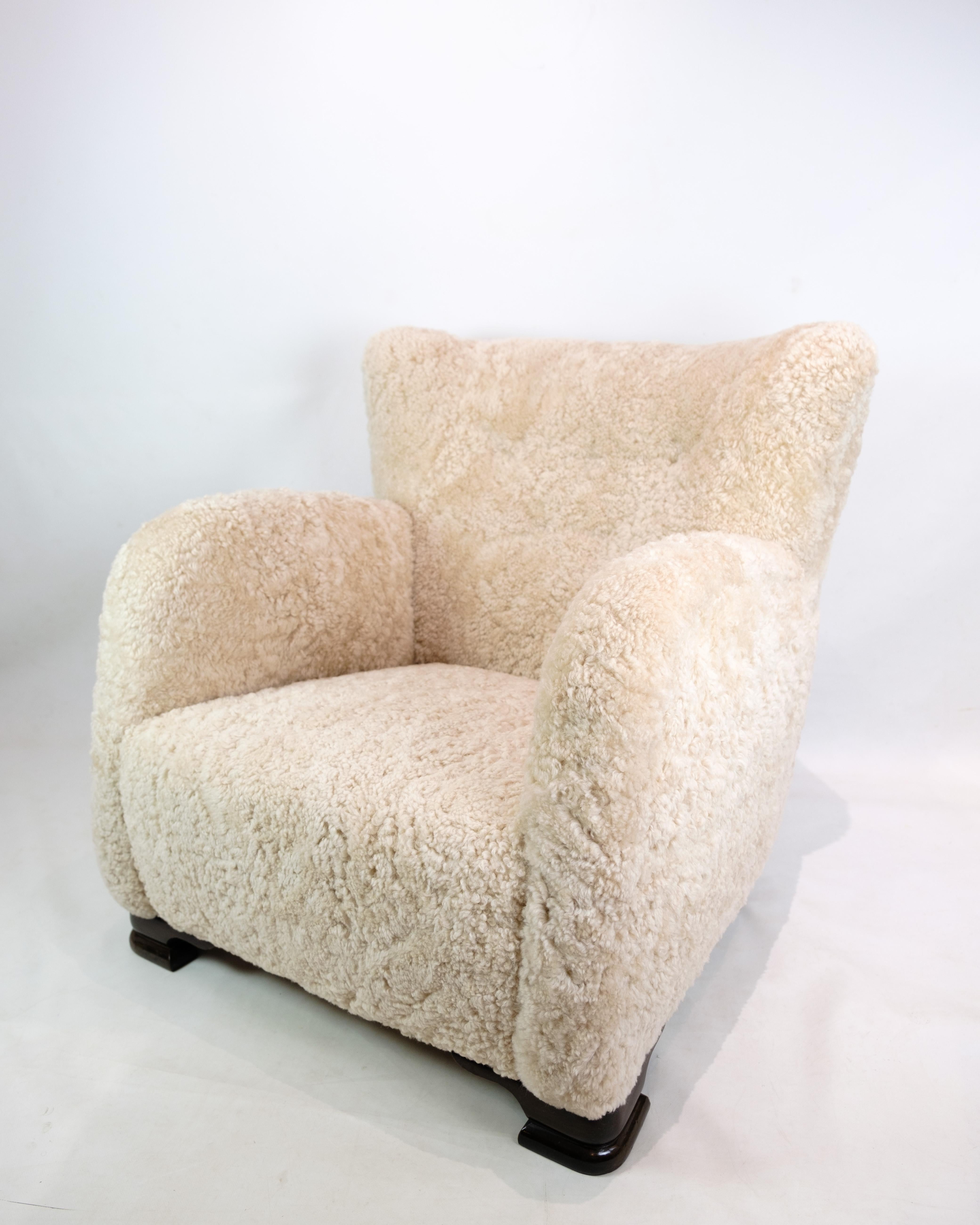 Danish cabinetmaker white coloured shearling - sheepskin 1940's lounge chair. A modern classic chair design with wide armrests that invite you to sit and look at as it features beautiful lines from every angle. The wide back and the very large