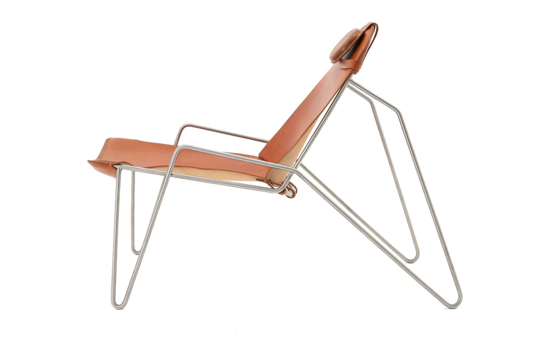 The easy chair features a handcrafted leather sling backrest and seat with adjustable belts on a solid stainless-steel frame. And a height-adjustable pillow that rests on a removable bikini trunk. The easy chair takes from the relaxed dropped curved