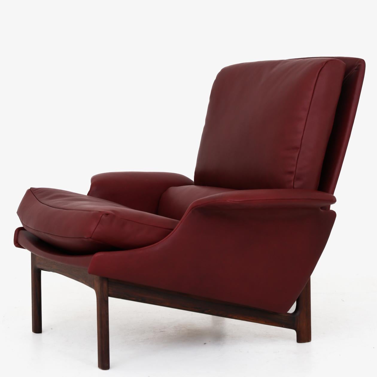 Reupholstered lounge chair and foot stool in 'Elegance' aniline leather (colour: Indian Red) on a rosewood frame. Designed in 1958. Ib Kofod Larsen / Mogens Kold.