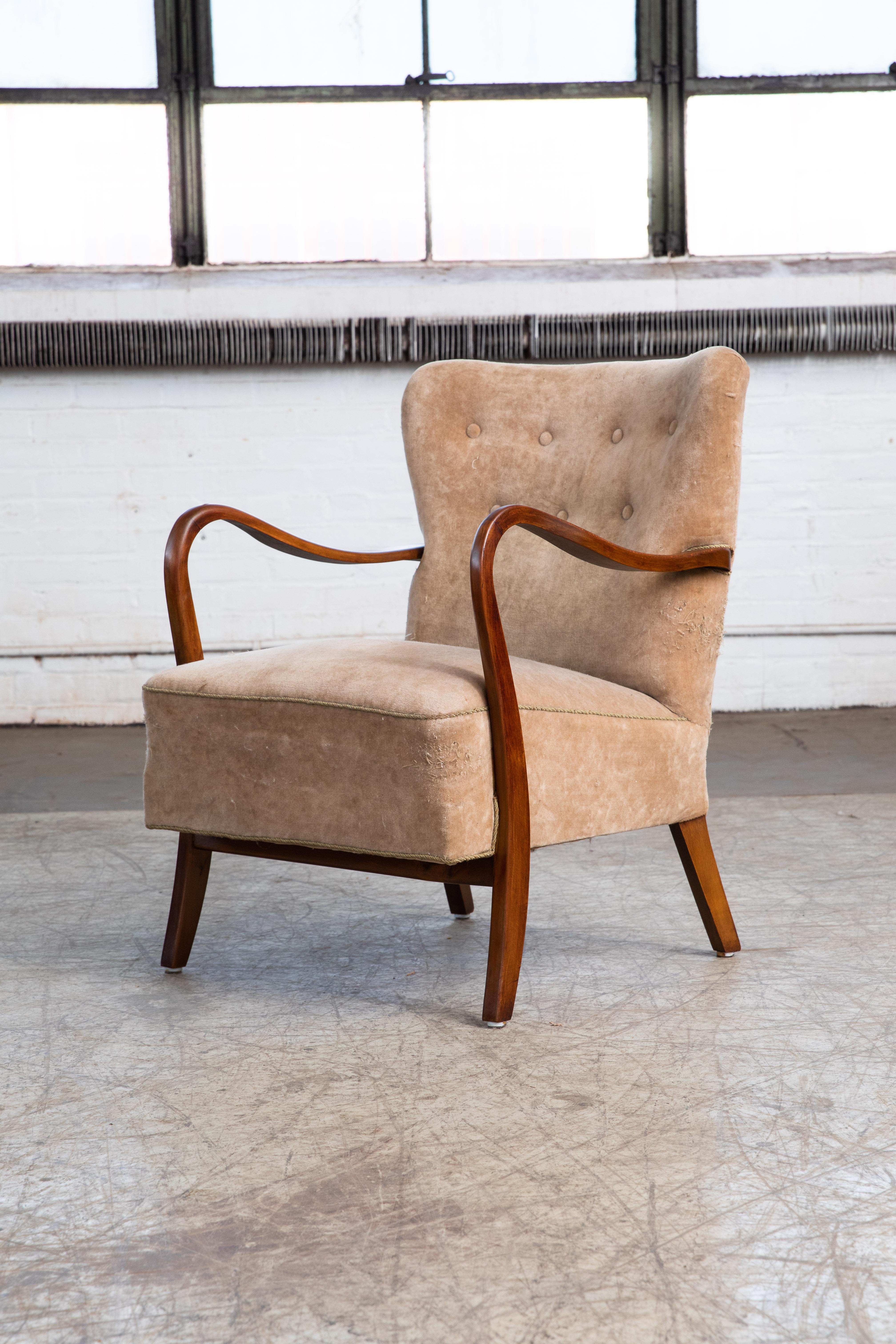 Classic elegant Danish high back armchair from the 1940s by Alfred Christensen for Slagelse Mobelvaerk with open armrests in beautifully curved mahogany stained beech. Nice slim elegant sculptural silhouette. We love how the armrest continues into
