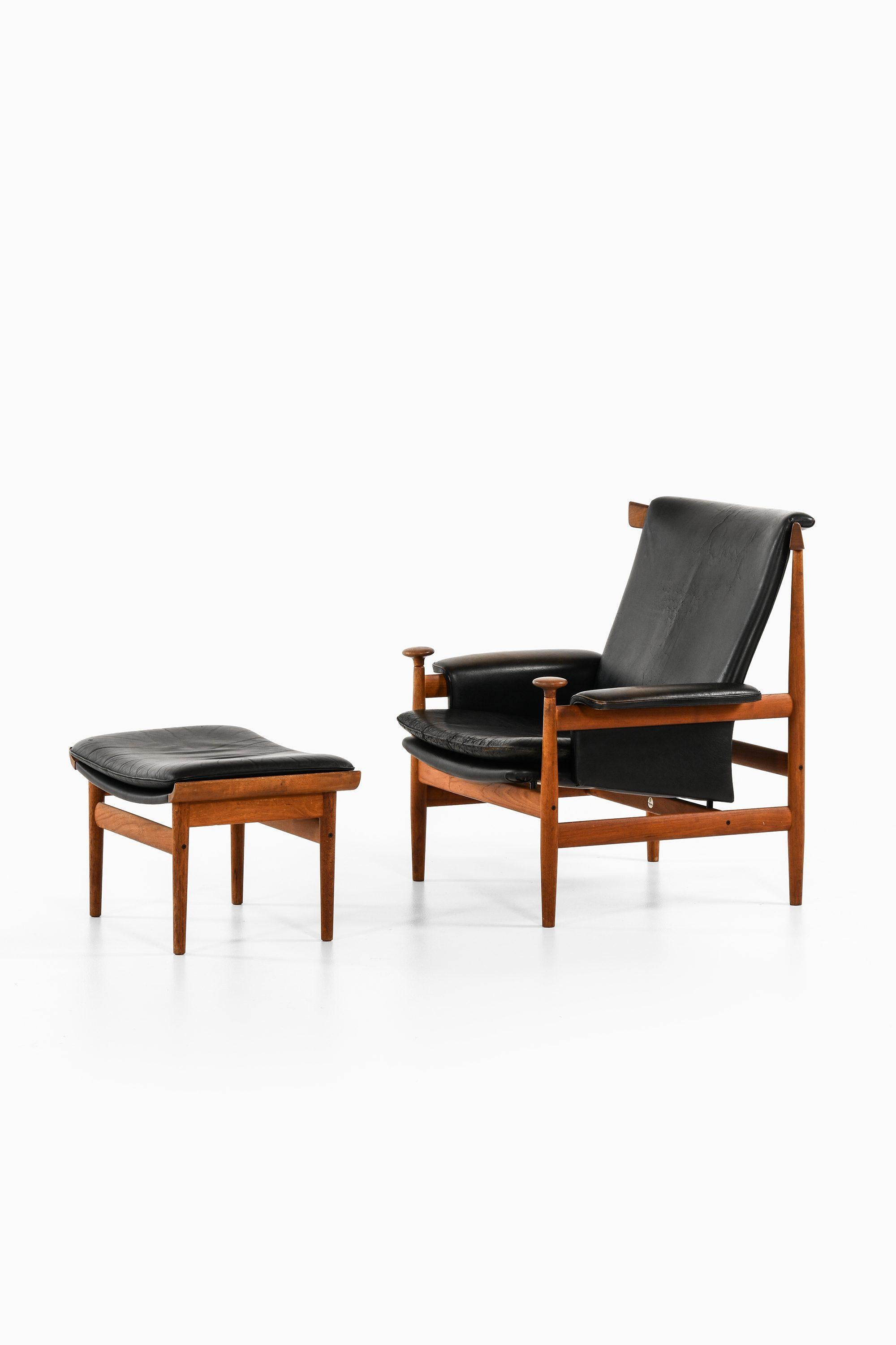 Danish Easy Chair with Stool in Teak and Black Leather by Finn Juhl, 1960's For Sale