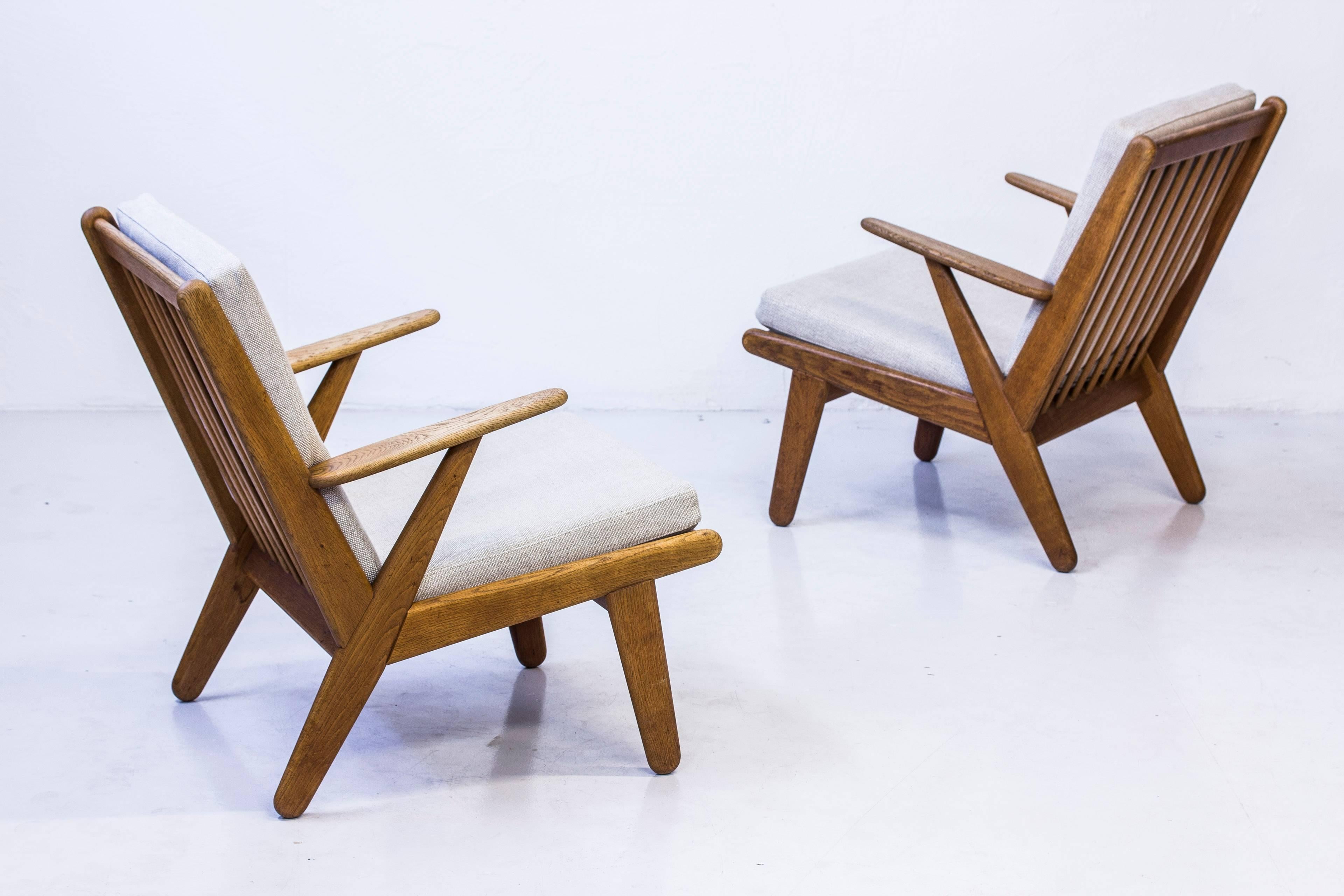 Pair of easy chairs designed by Poul Volther. Produced in Denmark by FDB during the 1950s. Made from solid oiled oak with new foam cushions and new upholstery in linen. Excellent condition with light age related patina and wear. 

Price for the