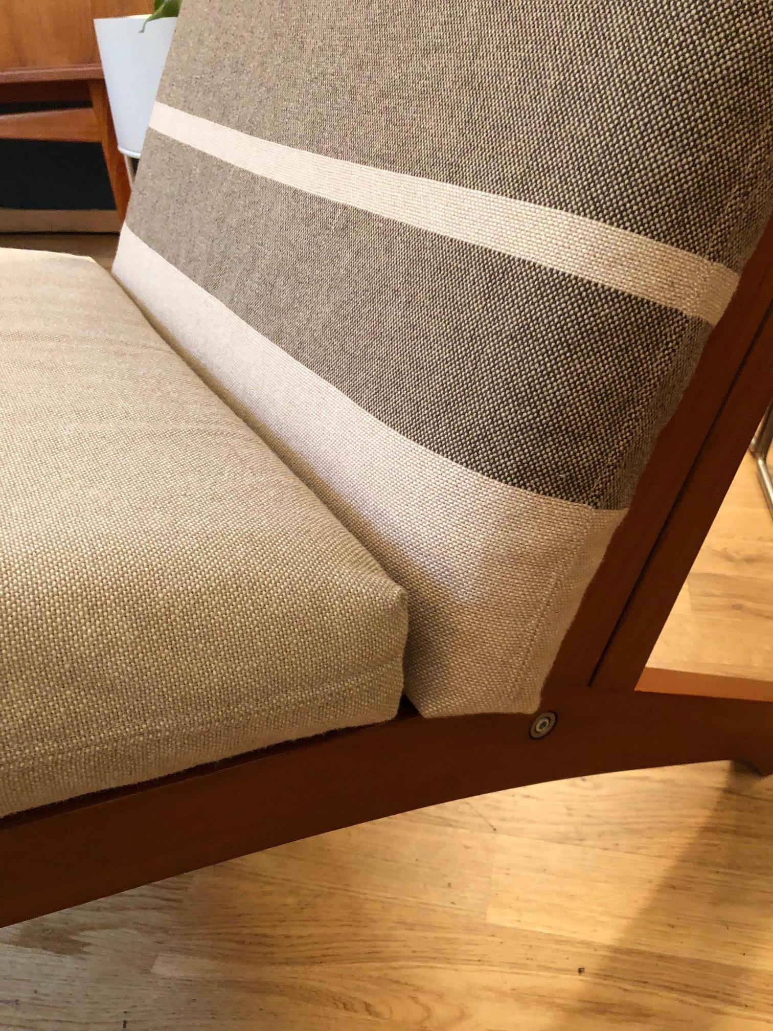 Sublime easy chair designed by Hans Wegner in 1969 and manufactured by GETAMA. This model is in teak wood with upholstered cushions in original covers. There are 2 identical chairs on request available.