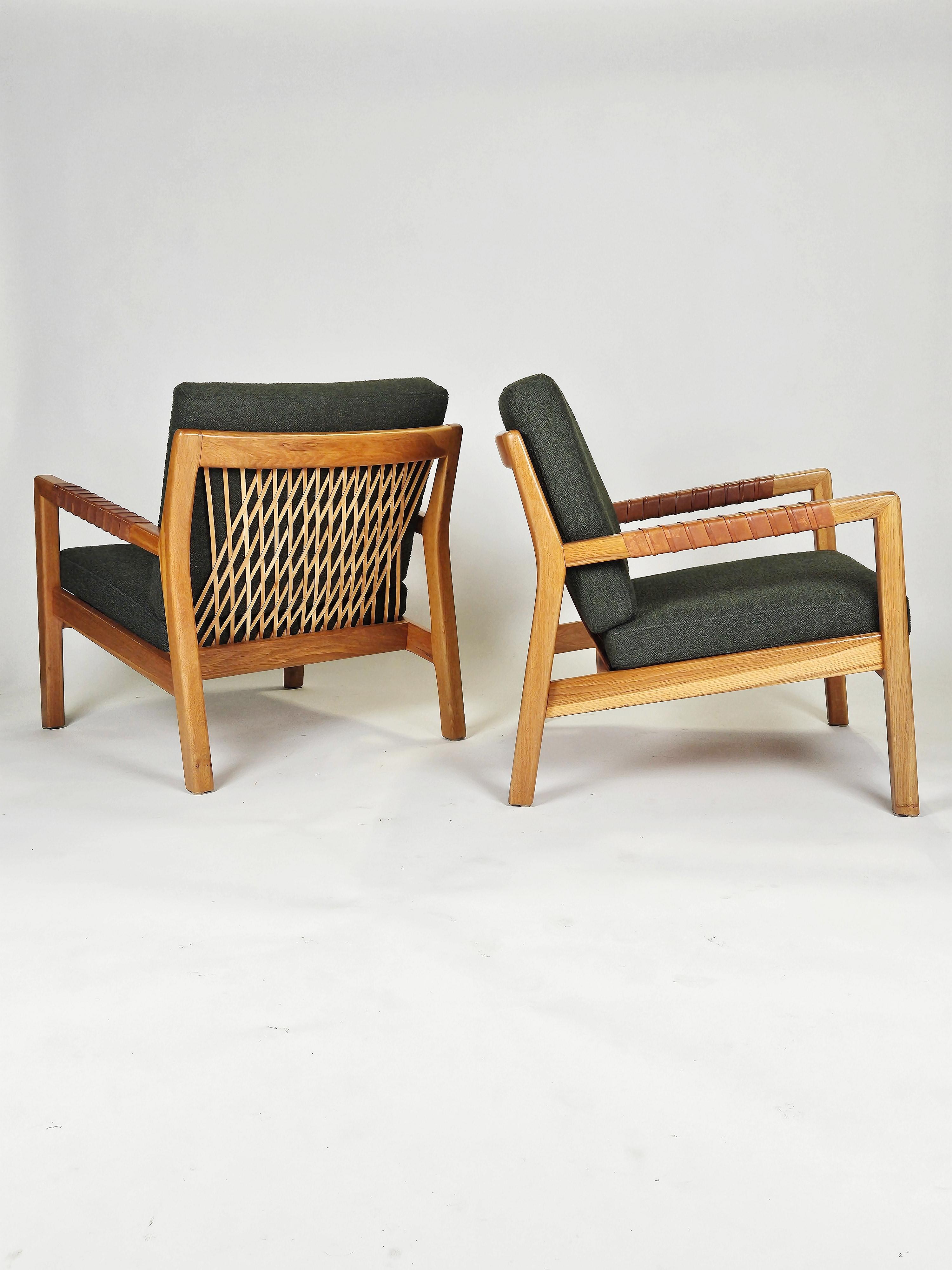 Rare pair of easy chairs designed by Carl Gustaf Hiort af Ornäs and produced by Puunveisto, Finland, during the 1950s. 

Made in ash with beautiful details of leather. Newly upholstered in high quality bouclé fabric in green. 


