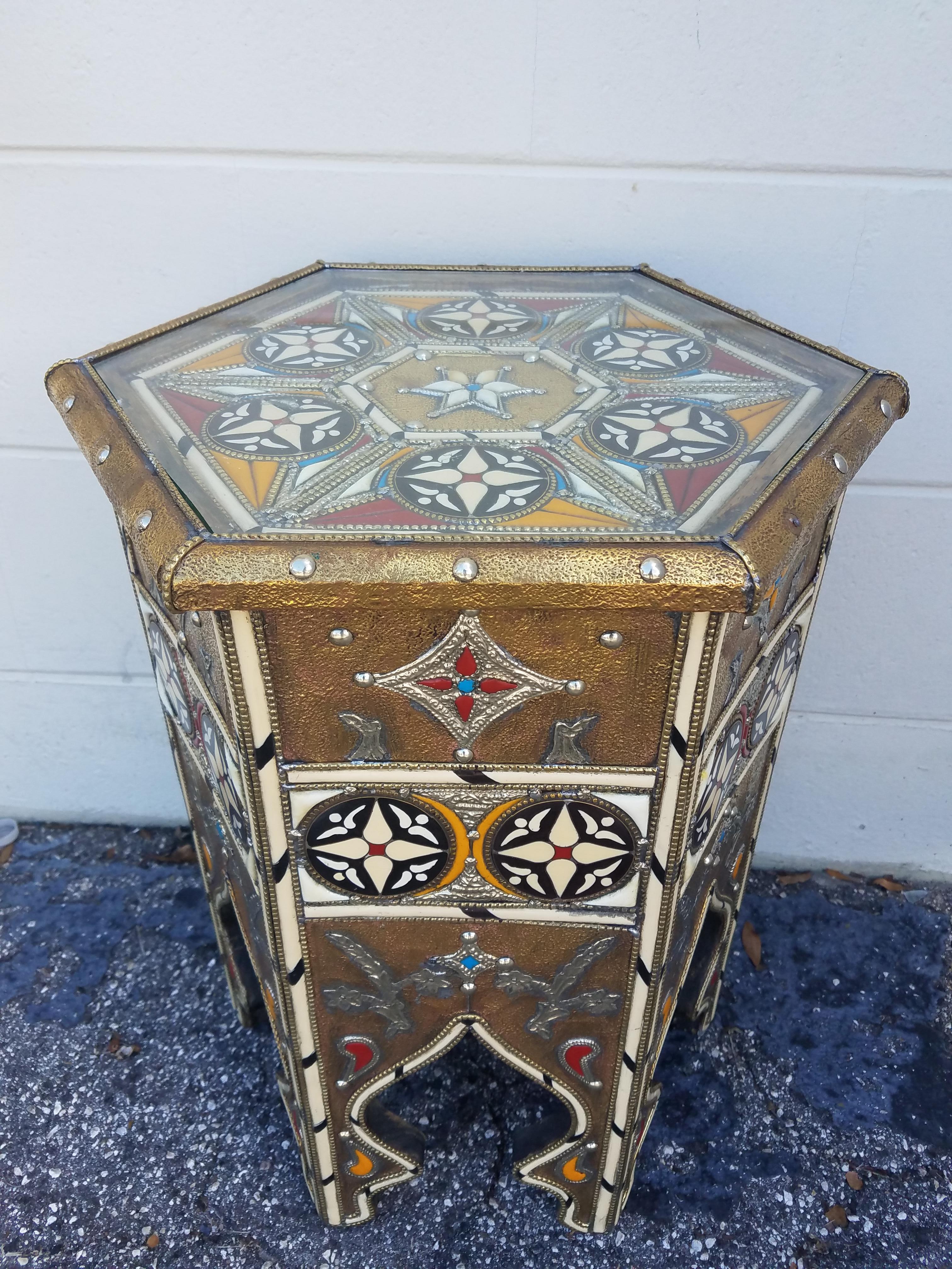A new arrival. This beautiful camel bone, resin, and metal inlaid Moroccan side table measures approximately 21