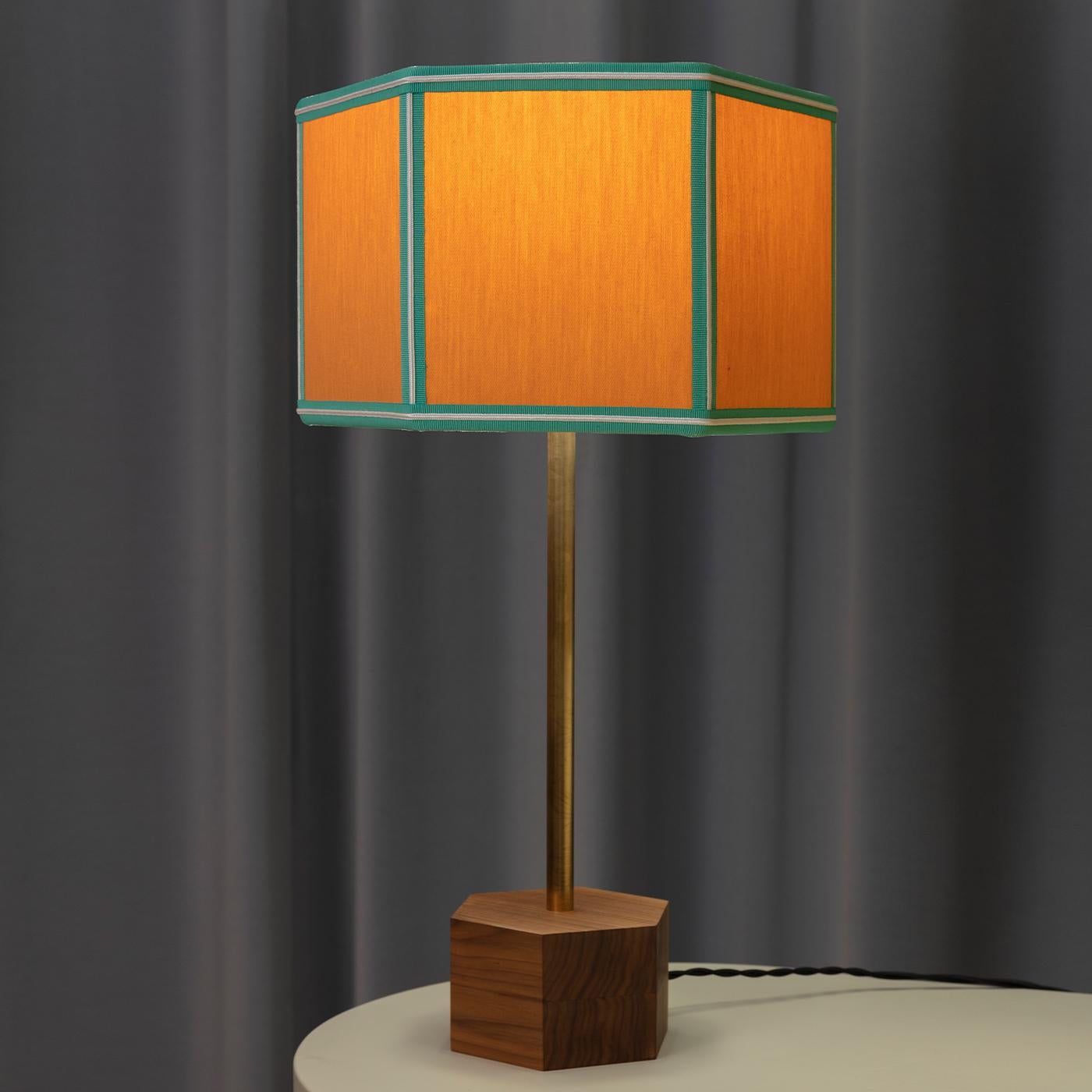The Easy Floor Lamp is all about simple classic geometry, masterfully revisited through various color combinations. The lampshade cotton fabric is presented in block colors with contrasted trimmings and fringing around the bottom rim. The hexagonal