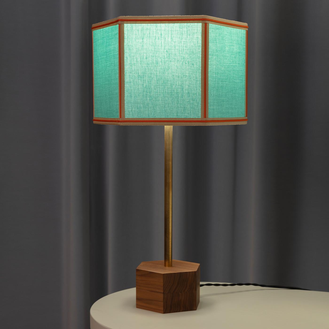 The Easy Floor Lamp is all about simple classic geometry, masterfully revisited through various color combinations. The lampshade cotton fabric is presented in block colors with contrasted trimmings and fringing around the bottom rim. The hexagonal