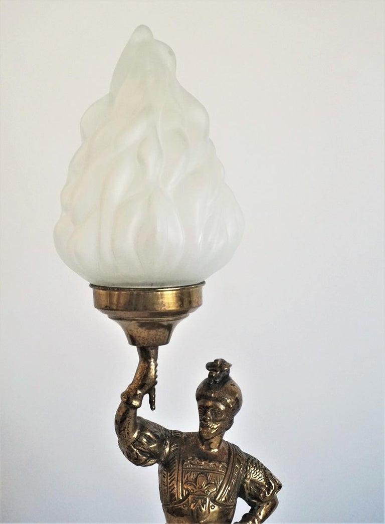 A solid bronze and brass knight sculpture candelabra later converted to electrified table lamp with large frosted glass torch flame shade.
European wiring: One E14 light bulb socket.
Total height: 23.75 in (60 cm)
Diameter: 6.25 in (16