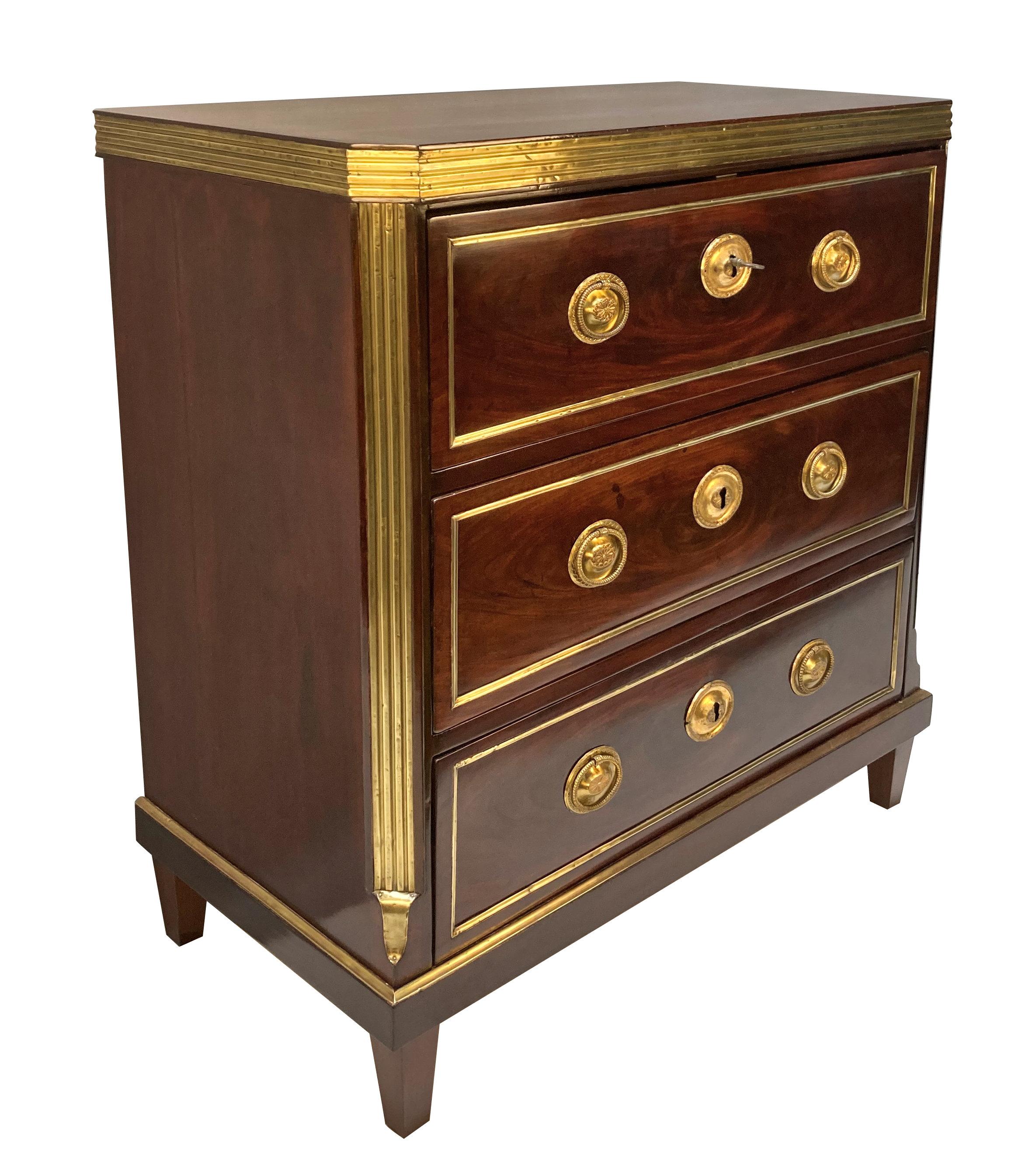 A fine early XIX Century Neo-Classical Russian commode of three drawers, in mahogany, with brass detailing throughout.