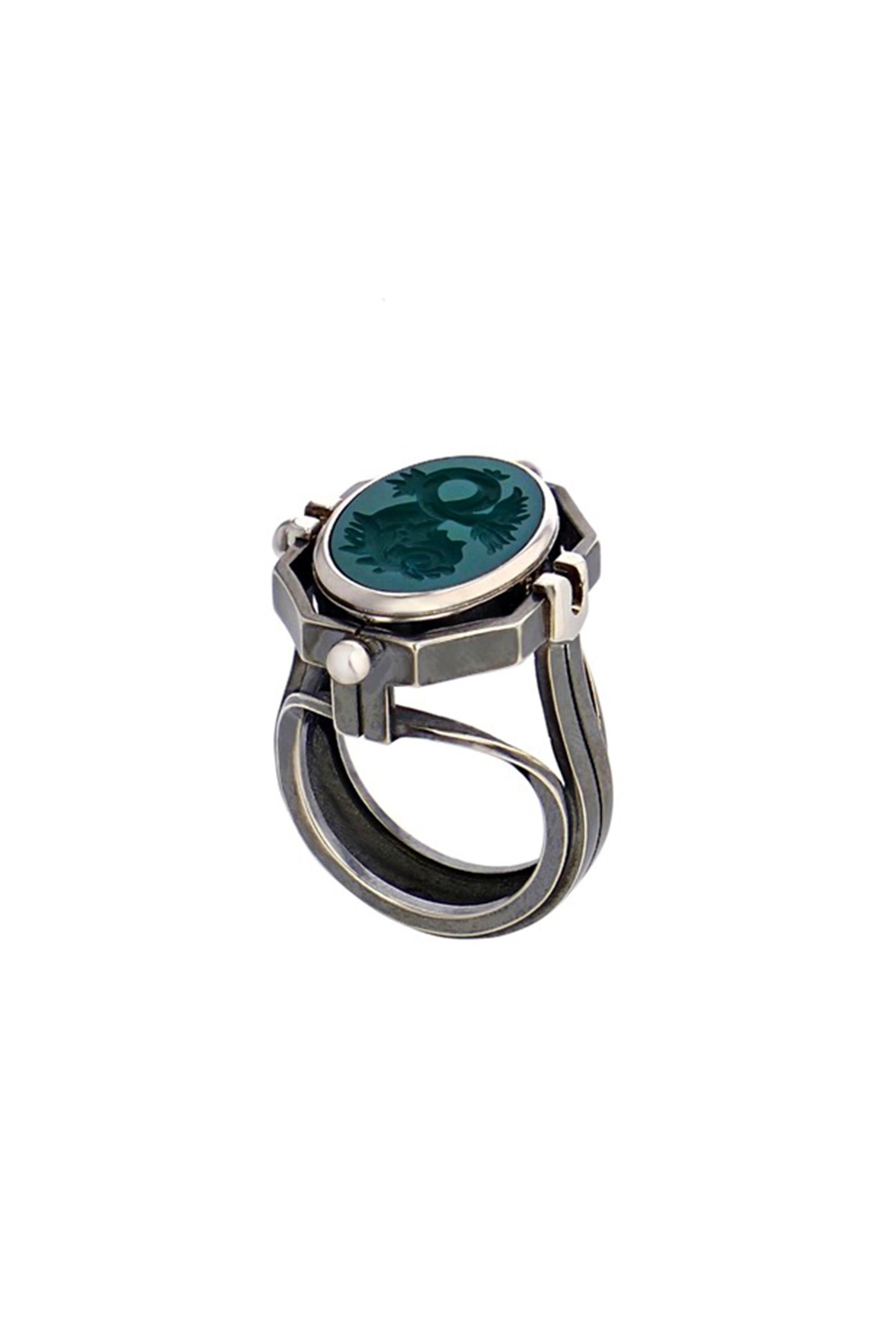 White gold and distressed silver ring. Rotating medallion: on the gold side are engraved Water signs (Cancer, Scorpio, Pisces) and on a green agate, a fish.

Details: 
Green Agate 
3 Diamonds: 0.06 cts
18k White Gold: 10g
Distressed Silver: 8g
Made