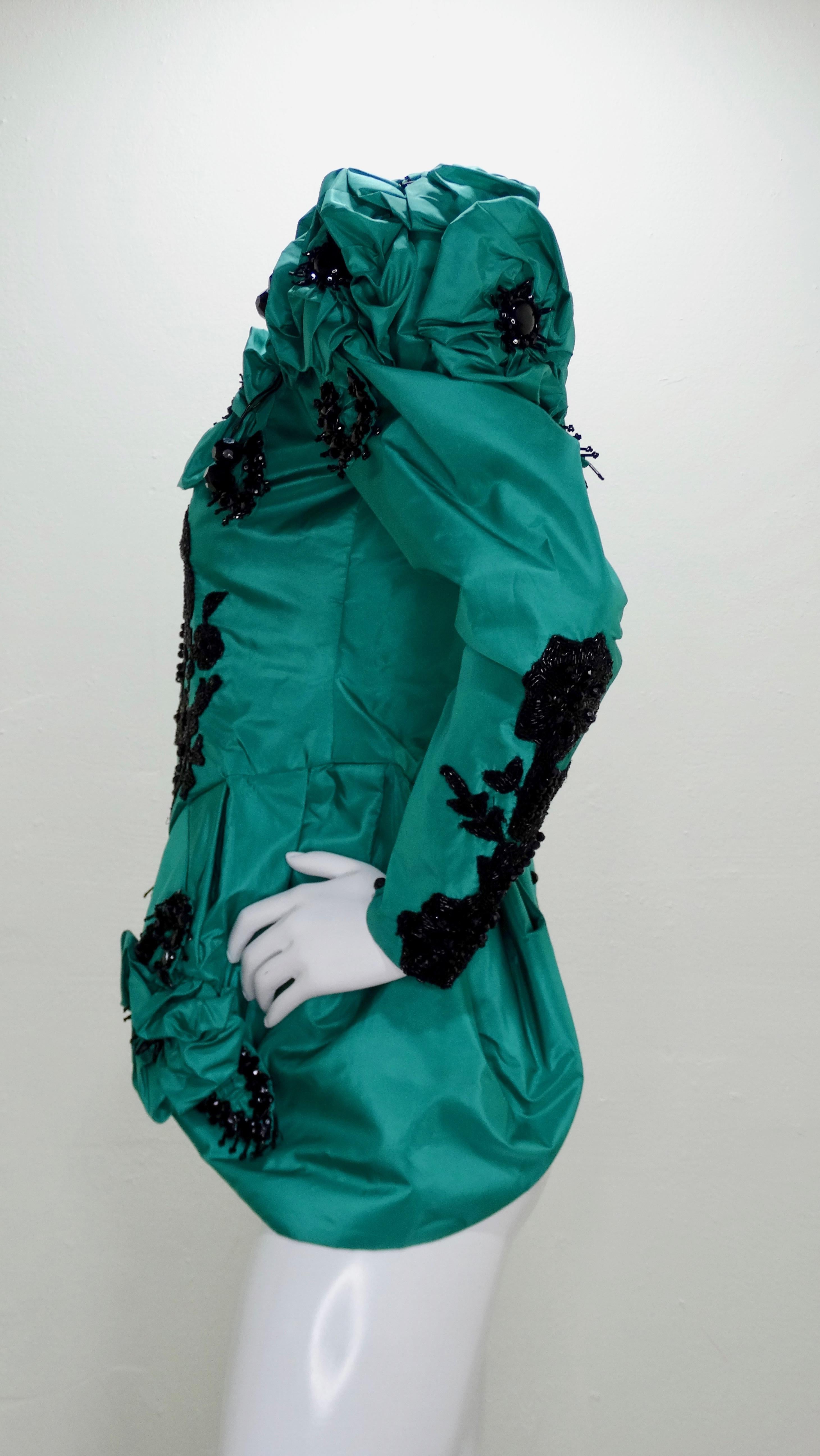 Now this is what we call vintage! Circa 1980s straight from London, this hand made Eavis and Brown for Capriccio haute couture blouse is crafted from rich green Silk and features leg-o-mutton sleeves with billowy fabric flowers and button cuffs, an