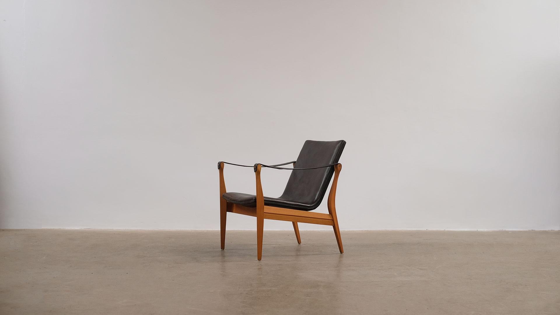 Very rare and beautiful chair in sculptured ashwood with amazing original black patinated leather designed in 1963 by Ebbe and Karen Clemmensen for Fritz Hansen, Denmark.