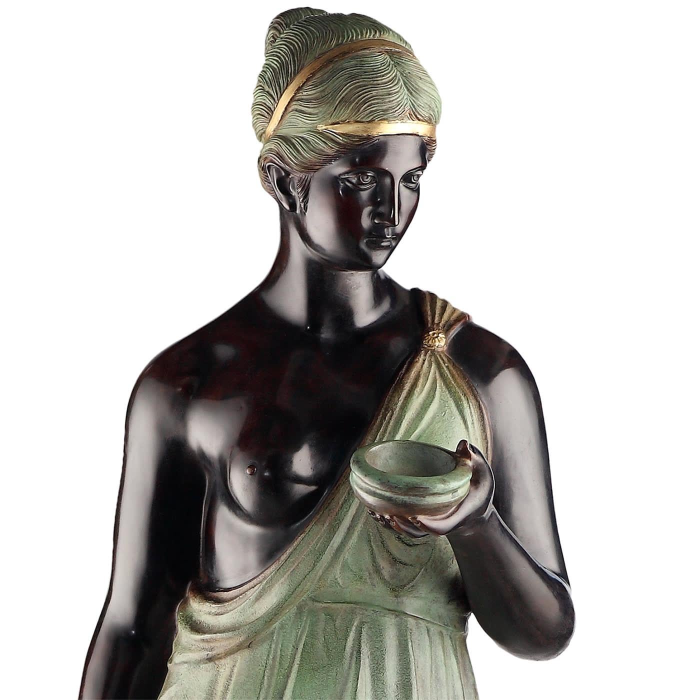 Crafted of bronze using the lost wax casting technique, this sumptuous statue echoes the glory of the ancient Greek myths reinterpreting them with a contemporary sensibility. A black Hebe - goddess of youth and cupbearer to the gods - is depicted
