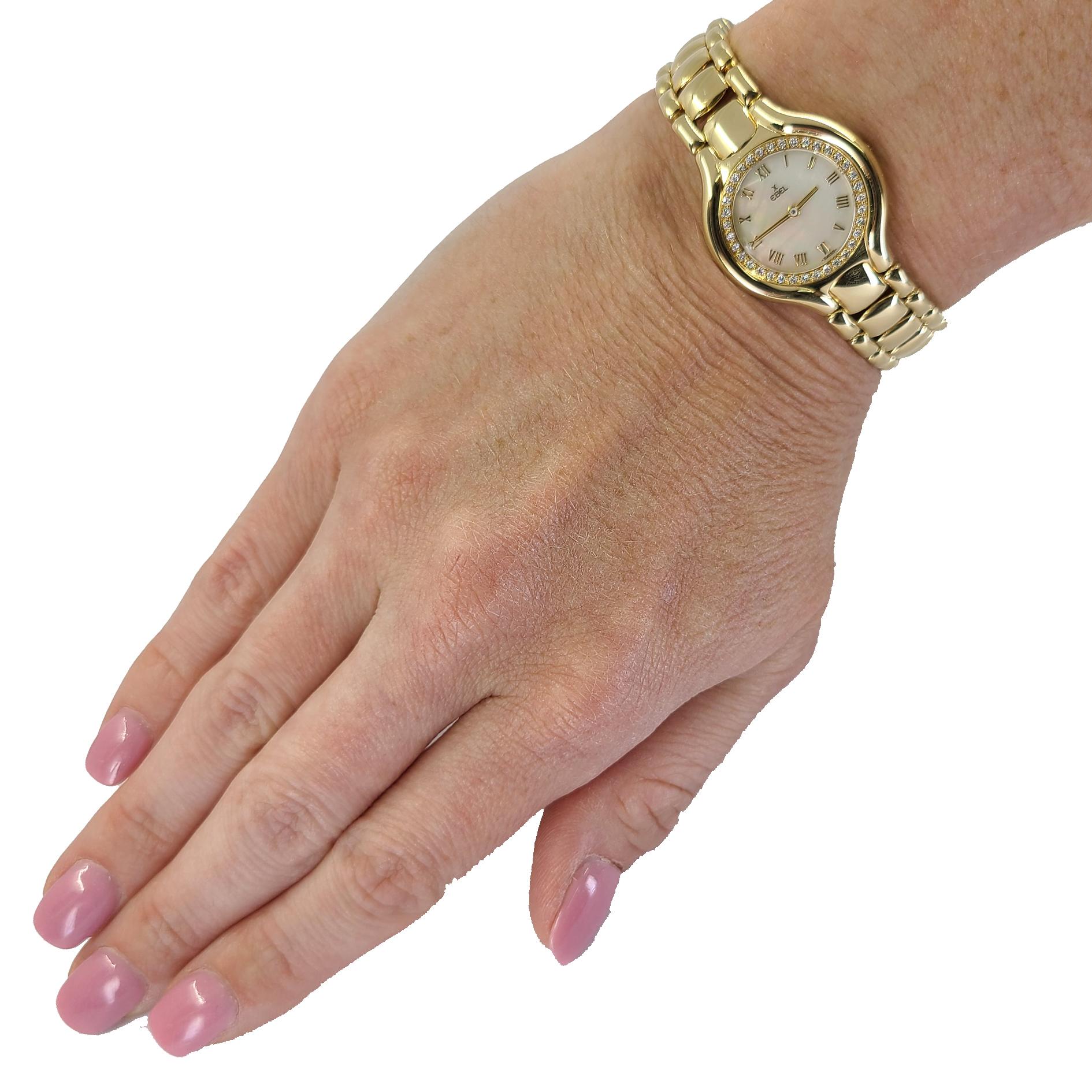 Pre-Owned 18 Karat Yellow Gold Ebel Beluga Wristwatch With Roman Mother of Pearl Dial, Diamond Bezel, & Hidden Folding Clasp. Quartz Movement. Caseback Numbers 42103262/866940. Includes 1 year timekeeping warranty.