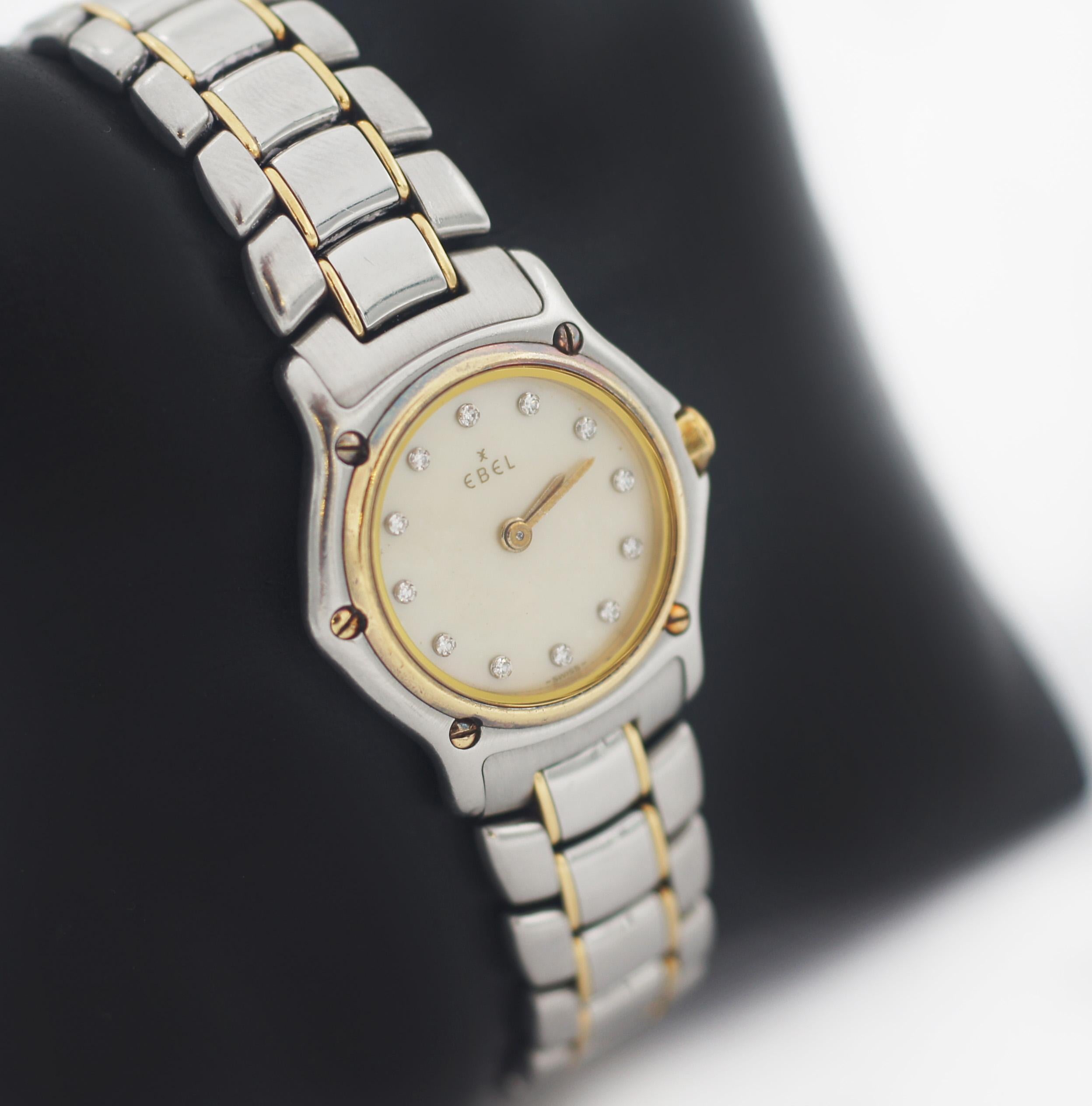EBEL
Stainless Steel & 18K Gold Bezel
2 tone
Mother of pearl Dial
Diamond Markers
Approx. Case 21mm
Swiss Watch
In great looking and working condition, visible wear consistent with time and some use. 
Such as light scuff, scratches or fading. 
See
