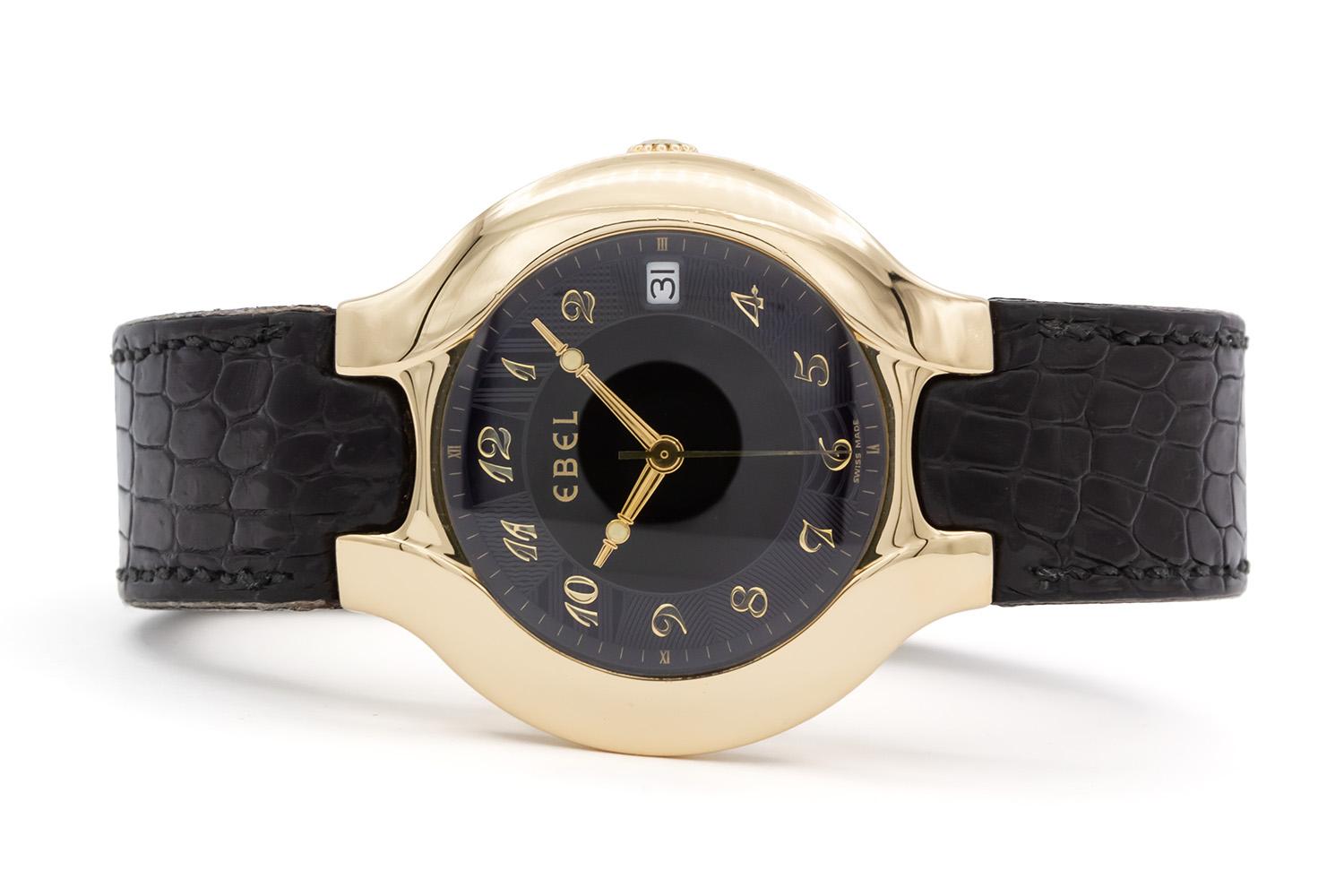 We are pleased to offer this Ebel 18k Yellow Gold Lichine Watch. This watch features a solid gold 37.5mm case, black Arabic dial with date aperture at 3 o'clock, Swiss automatic movement and genuine Ebel black leather strap with 18k yellow gold