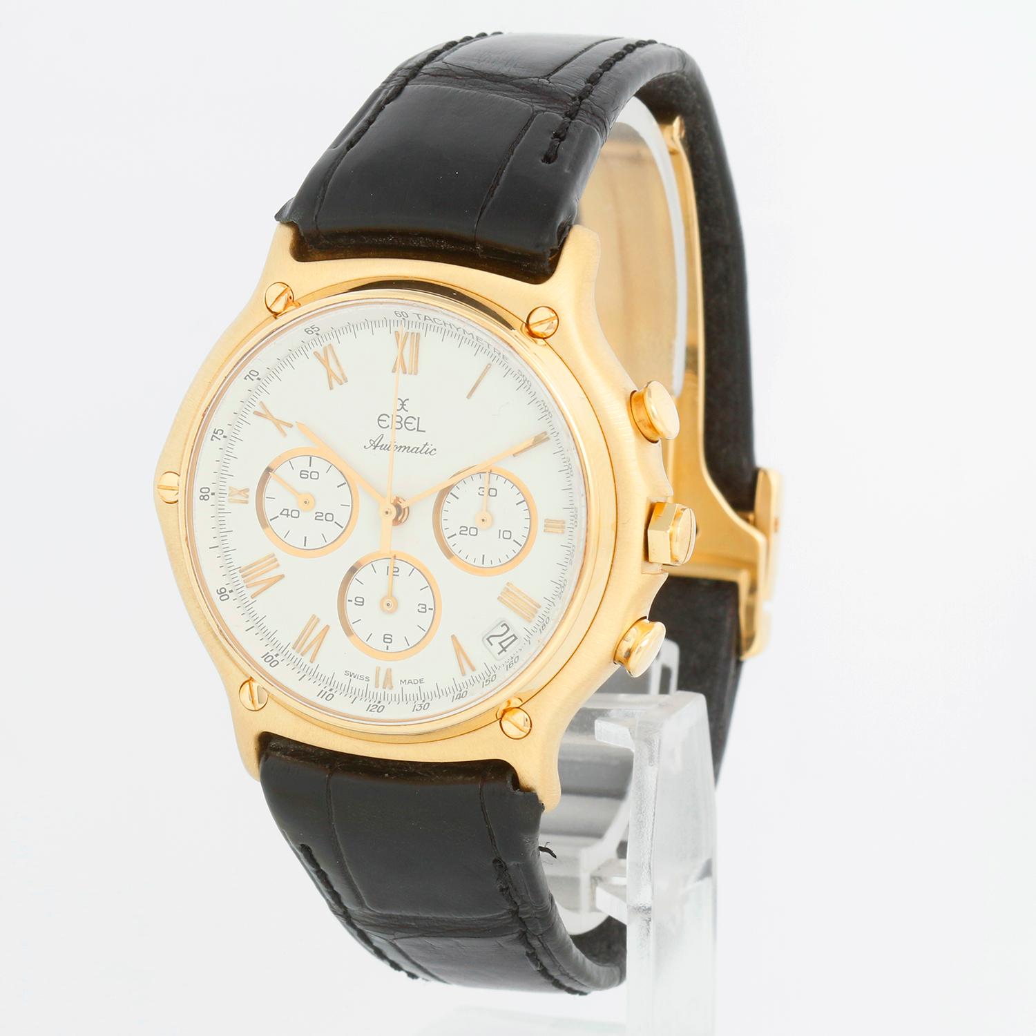 Ebel 1911 Chronograph Men's 18K Yellow Gold Watch  Ref. 8134901 - Automatic. 18k yellow gold case with 18K yellow gold bezel (38 mm). White dial with gold Roman numerals. Leather strap with 18k yellow gold deployant clasp. Pre-owned with Ebel box
