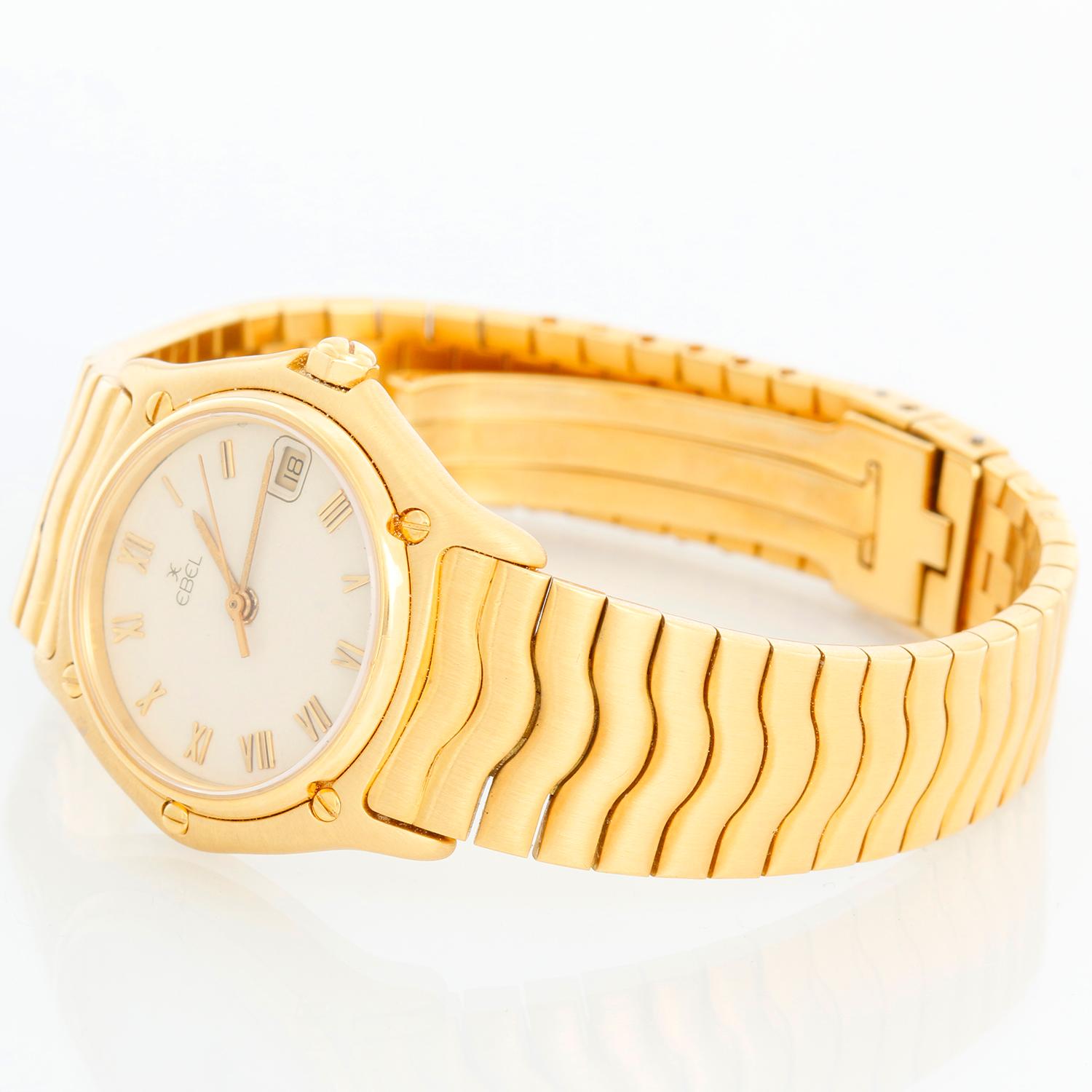 Ebel 1911 Classic Wave 18k Gold Watch Sportwave Bracelet Quartz - Quartz. 18k yellow gold case (24mm diameter). Ivory colored dial with gold Roman numeral. 18k yellow gold Sportwave bracelet. Pre-owned with Ebel box and books. 