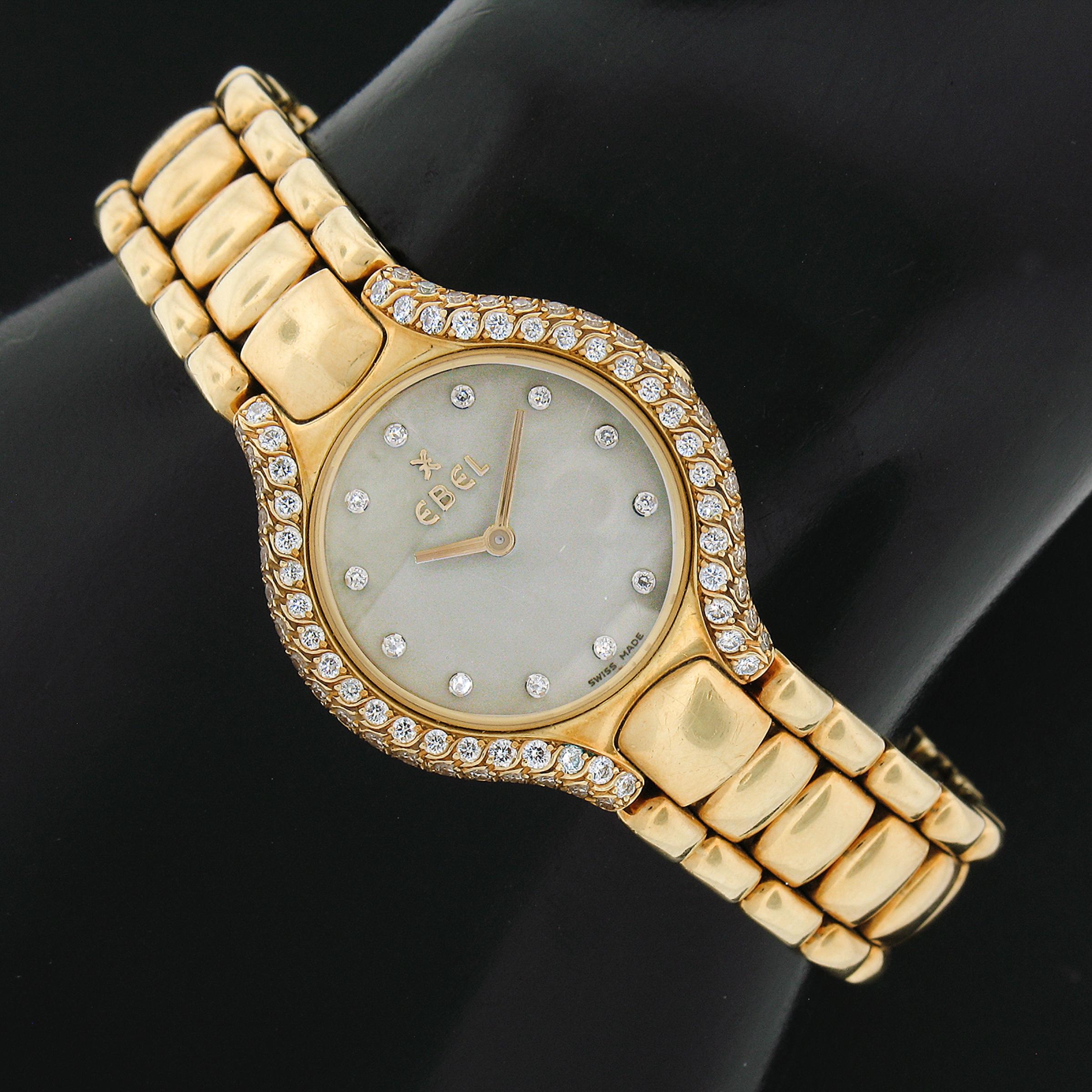 This stunning ladies' Ebel Beluga wrist watch features a 24mm solid 18k yellow gold round shaped case encrusted with outstandingly fine quality diamonds throughout totaling approximately 1.11 carats in weight. The bracelet is secured with a