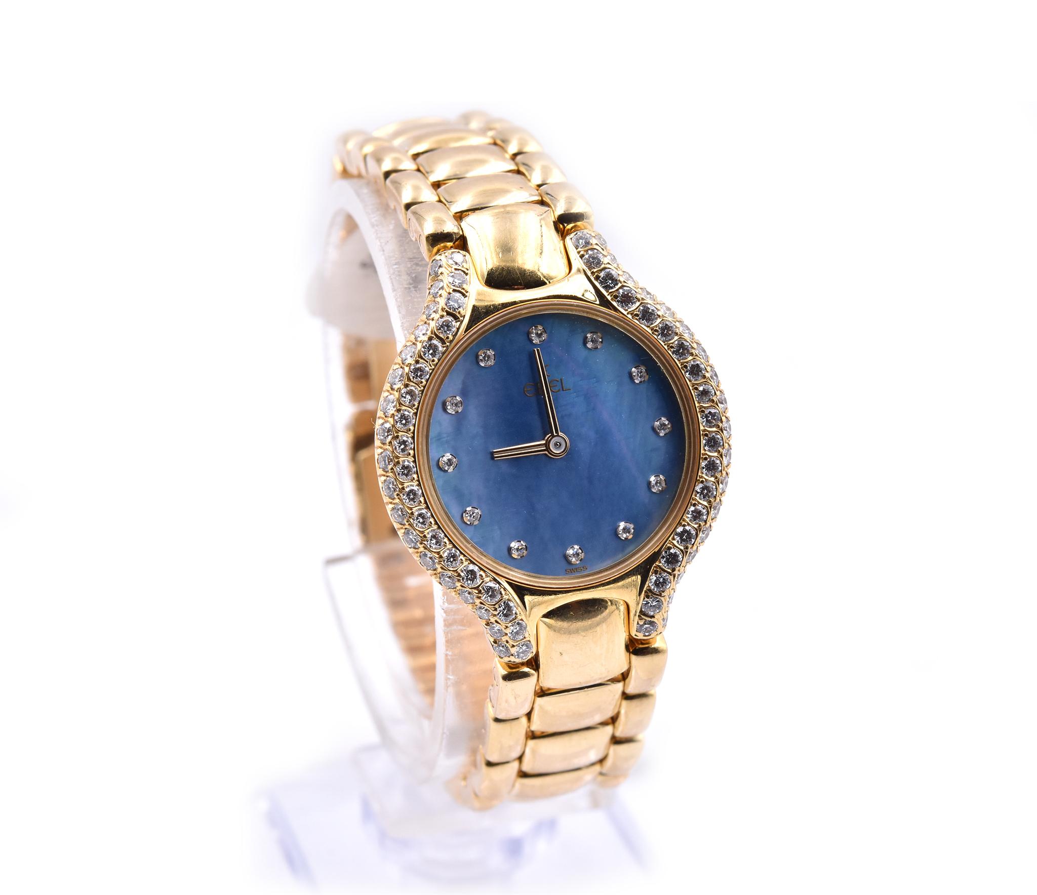 Movement: automatic
Function: hours, minutes 
Case: round 24mm yellow gold case, sapphire crystal, pave set diamond bezel, push/pull crown
Band: Ebel yellow gold bracelet with deployment clasp
Dial: blue mother of pearl dial, diamond hour