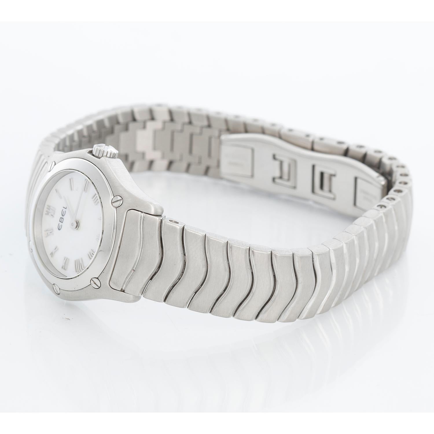 Ebel Classic Wave Mother of Pearl Ladies Watch - Quartz movement. Stainless steel case (23mm diameter). Mother of Pearl Dial. Stainless Steel bracelet will fit up to a 7 inch wrist. Pre-owned with Ebel box