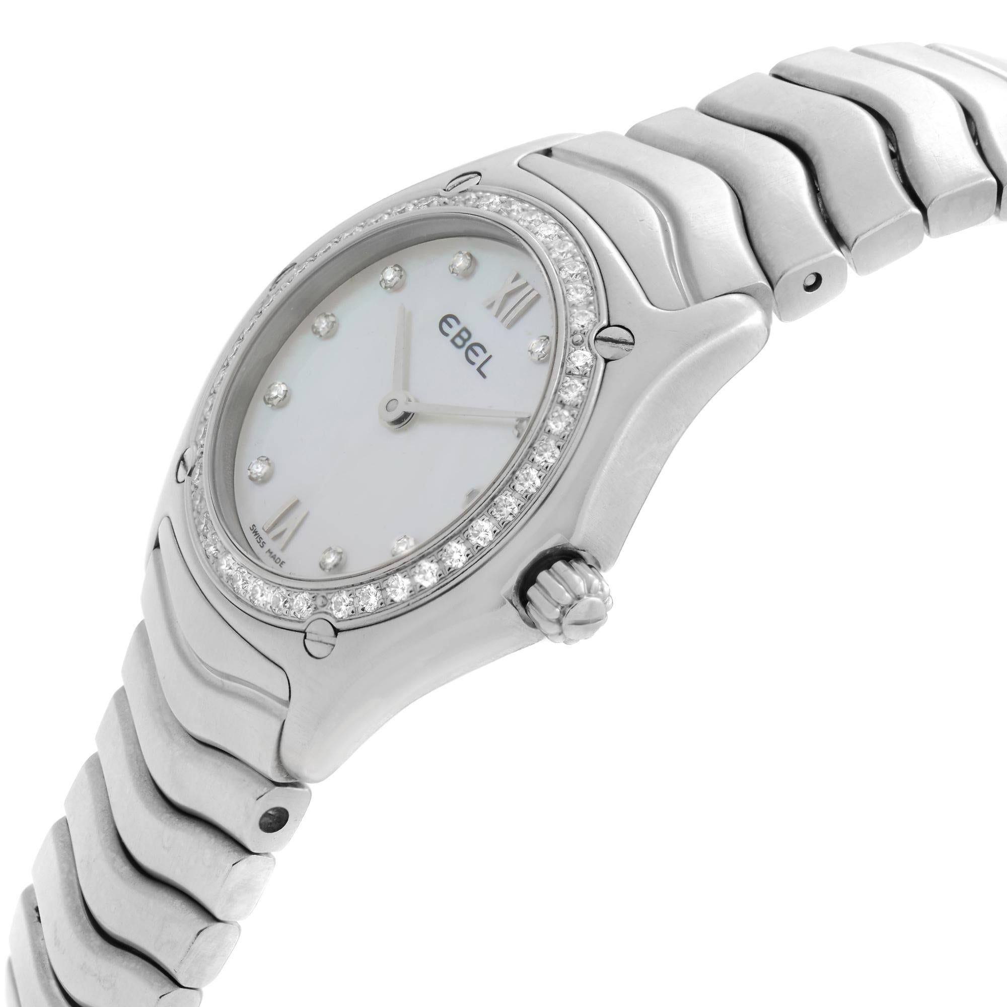 Pre Owned Ebel Classic Wave Steel MOP Dial Diamond Bezel Ladies Quartz Watch 9090F24-9725. This Beautiful Timepiece is Powered by Quartz (Battery) Movement And Features: Round Stainless Steel Case & Bracelet Fixed Stainless Steel Diamond Set Bezel,