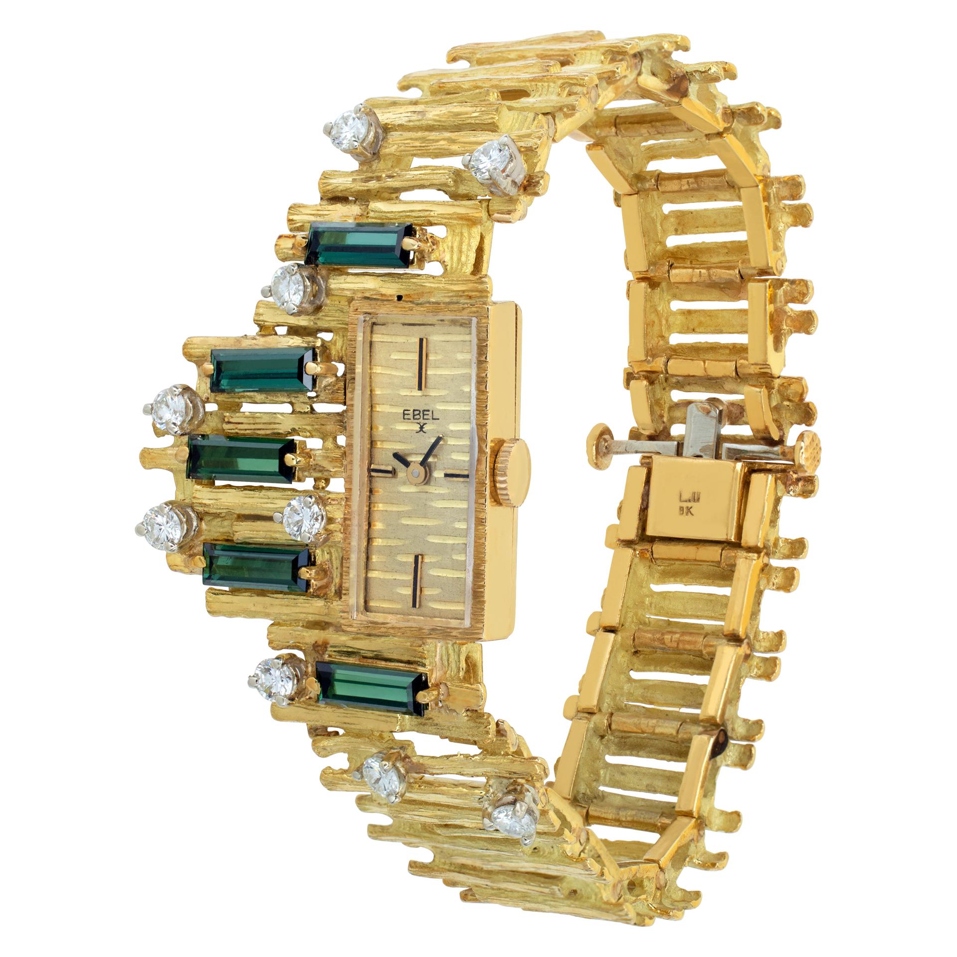 Ebel Vintage Cocktail watch with tourmalines and diamonds in 18k yellow gold with bark finish bracelet. Approximately 1 carat in G-H color, VS clarity diamonds. Total length 6.5 inches. Case measures 20mm long by 10mm wide. Circa 1956. Fine