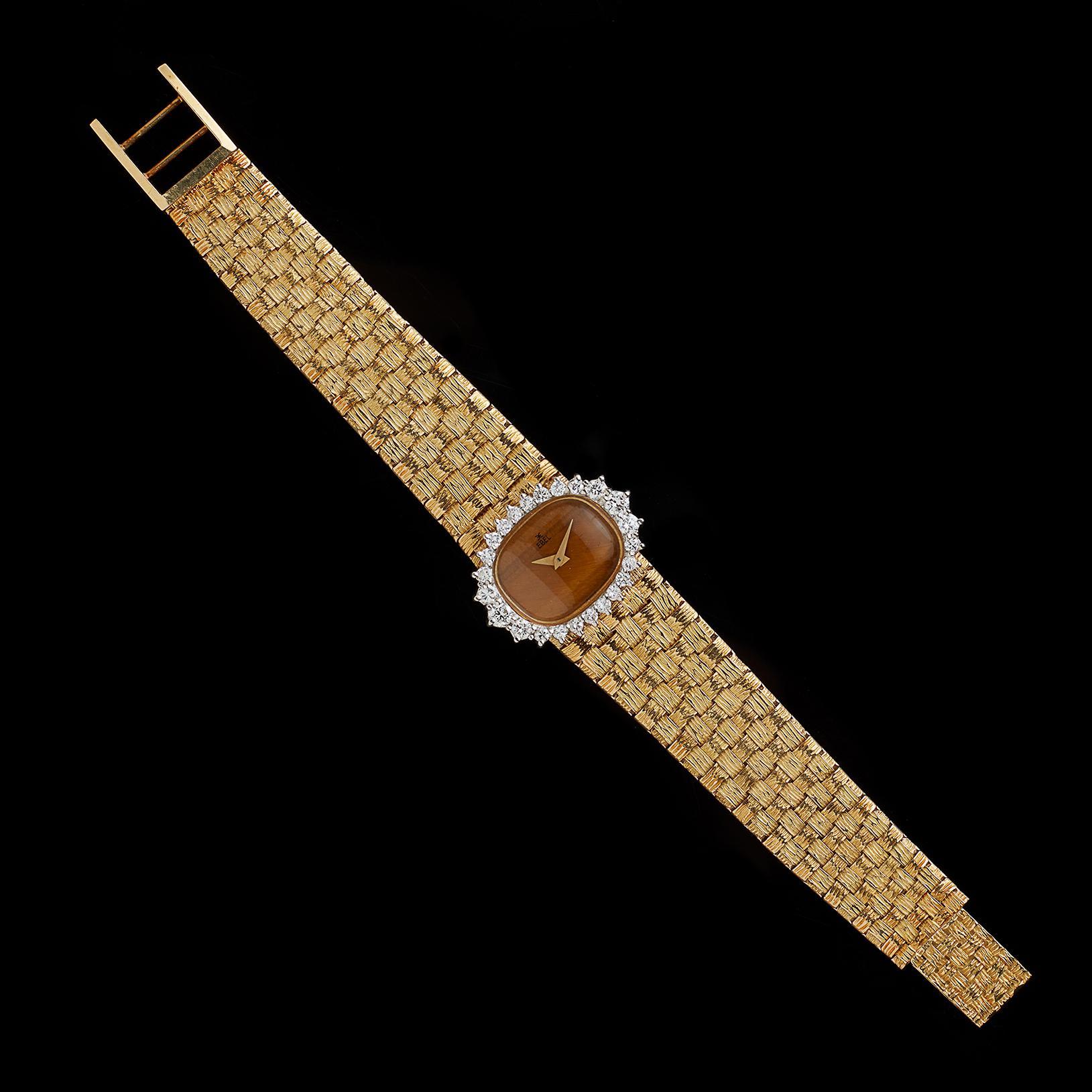 Circa 1970's, this ladies Ebel watch is a unique find! The oval tiger's eye dial is surrounded by 24 round brilliant-cut diamonds, weighing in total approximately 1.00-cts (G-H/VS). And with a tapering, woven mesh gold strap bracelet, telling the