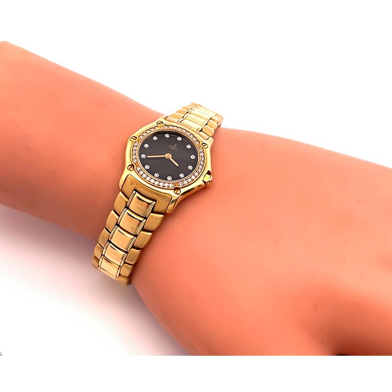 This is a fabulous 18k yellow gold diamond Ebel women's Swiss watch. The watch features black dial with gold bars time markers and diamond accent. The case, band and the dial are signed Ebel. The case measures 28mm by 24mm. The watch weighs 74.5