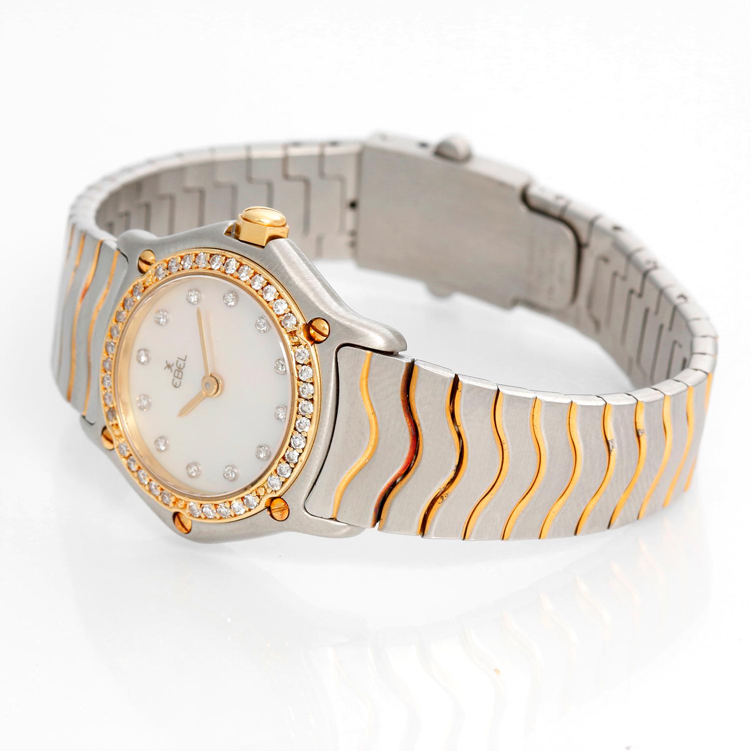Ebel Ladies 2-Tone Mother of Pearl Diamond Wave Watch - Quartz movement. Stainless steel case with diamond bezel (23mm diameter). Mother of pearl dial with diamond hour markers. Stainless steel Ebel bracelet with gold accents (will fit a 5 3/4