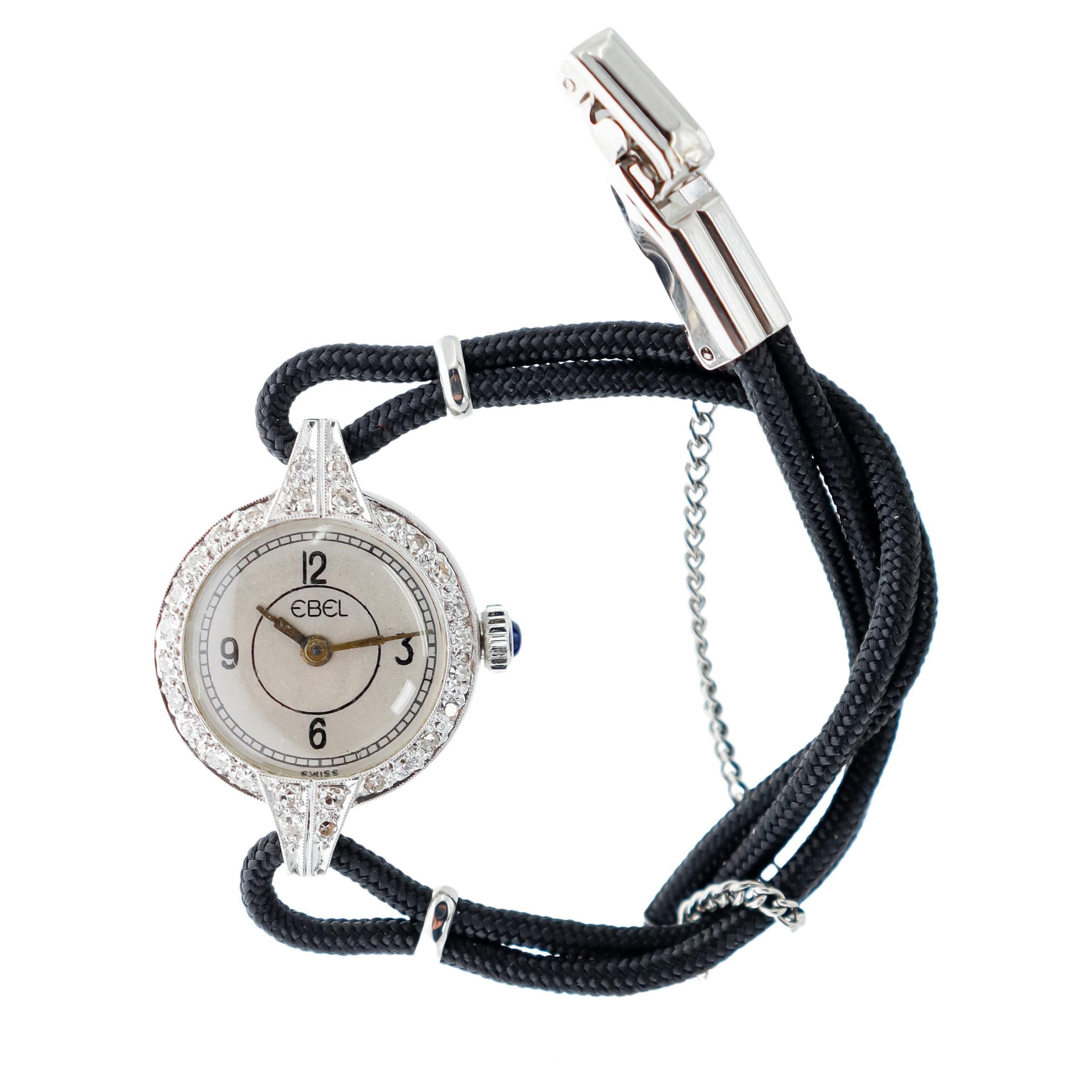 FACTORY / HOUSE: Ebel Watch Company
STYLE / REFERENCE: Round Art Deco 
METAL / MATERIAL: Platinum
CIRCA / YEAR: 1930's
DIMENSIONS / SIZE: Length 26mm X Diameter 19mm 
MOVEMENT / CALIBER: Manual Winding / 17 Jewels 
DIAL / HANDS: Silvered with Arabic