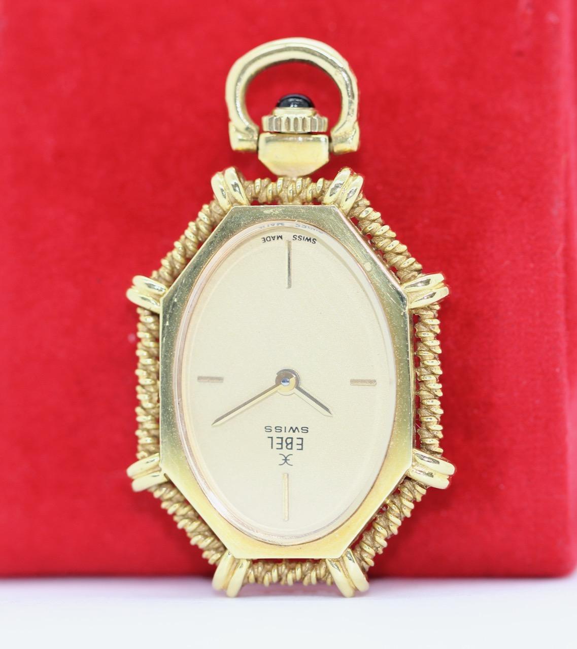 Charming Ebel ladies watch as pendant, 18k gold.

Case made of solid 18k yellow gold. Sapphire crystal. 
Crown with sapphire cabochon.
Mechanical hand-wound movement. Fully functional.

Includes certificate of authenticity.