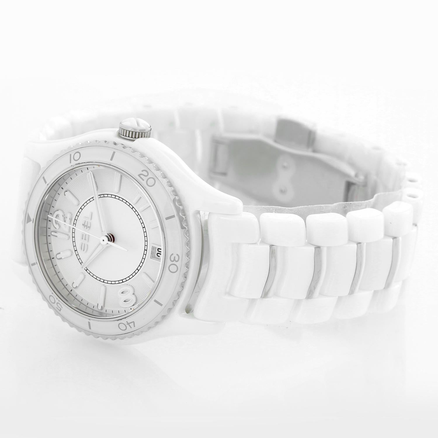 Ebel X-1 Silver Dial White Ceramic Ladies Watch 1216129 - Quartz. White ceramic case;  uni-directional rotating stainless steel bezel with a white ceramic top ring. Silver dial with luminous silver-tone hands and index hour markers. Arabic numerals