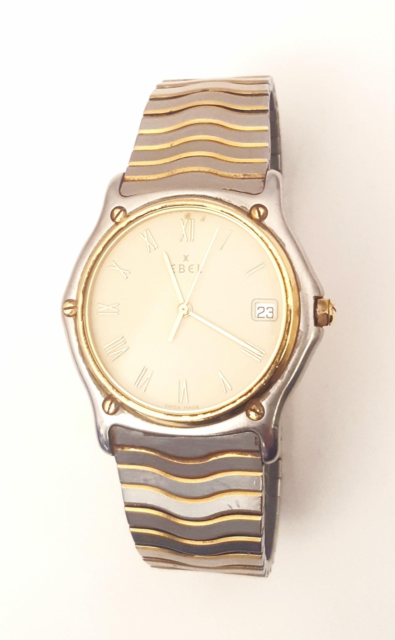 A fabulous Ebel watch suitable for men or women who are wearing larger watches!  Swiss made, sapphire crystal, case measures 37mm, Roman numerals on champagne dial, sweep second hand, deployment clasp, date window.  Named Wave after the bracelet