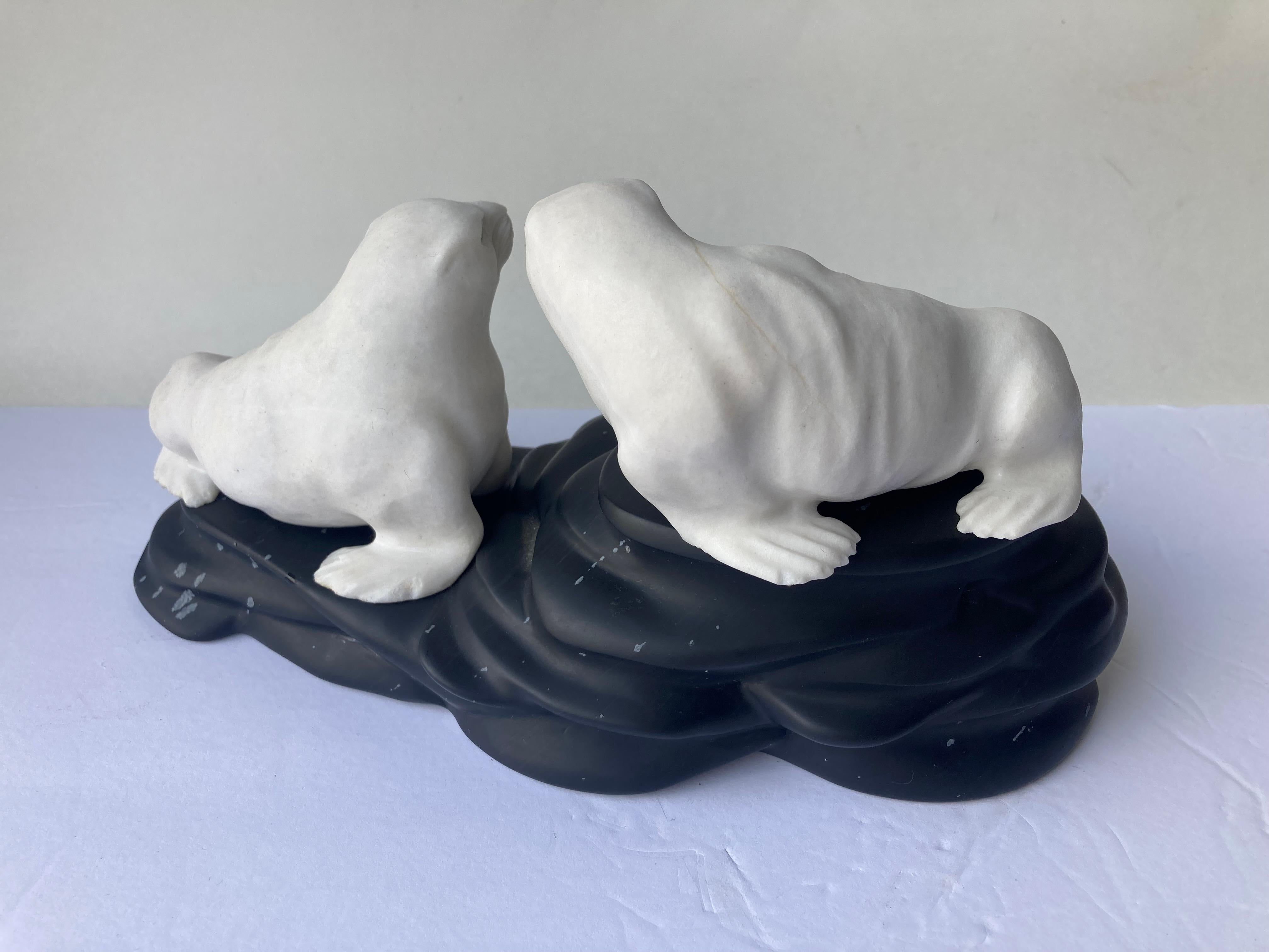 This an amazing carving by the German certified artist Eberhard Bank. This sculpture is of two seals in white dolomite on snowflake black obsidian , seals are marked with monogram EB as shown in picture.