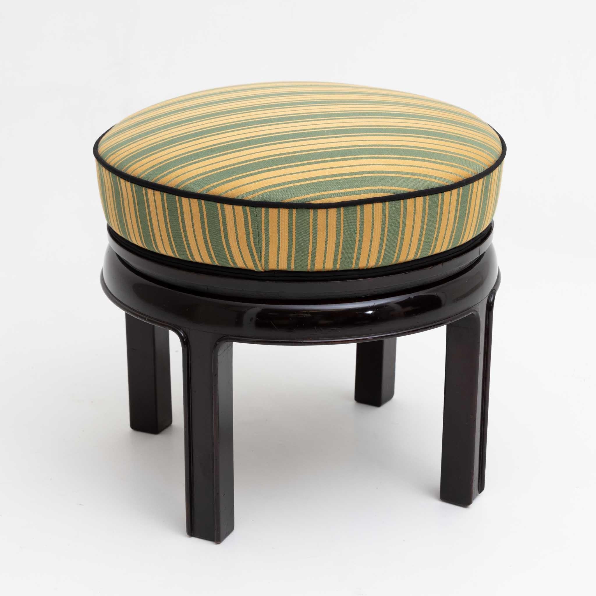 Art Deco stool with round upholstered seat and ebonised frame on four straight legs. The green and yellow striped cover is new and has been trimmed with black piping.
