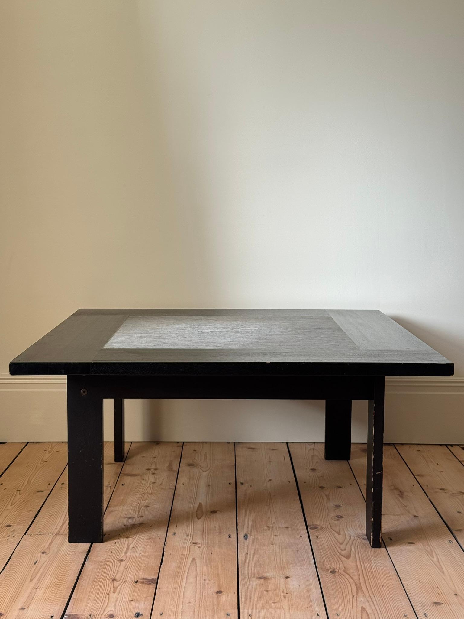 A square coffee table in ebonised ash with a stone centre. Good vintage condition showing more signs of wear around the edges of the legs.

Denmark c. 1970s

H45 x W95 x D95cm