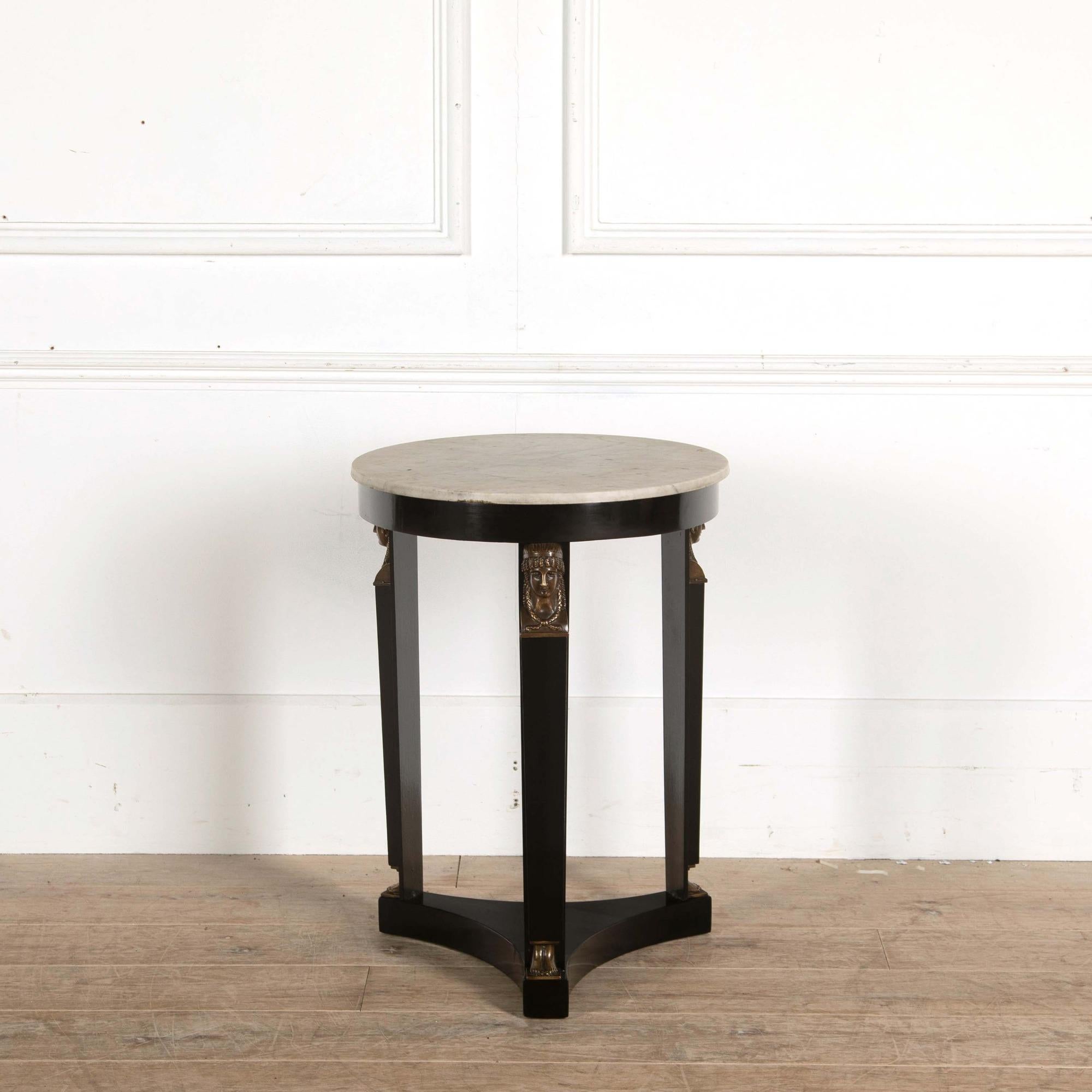 A French ebonized and bronze mounted Directoire marble-top table.