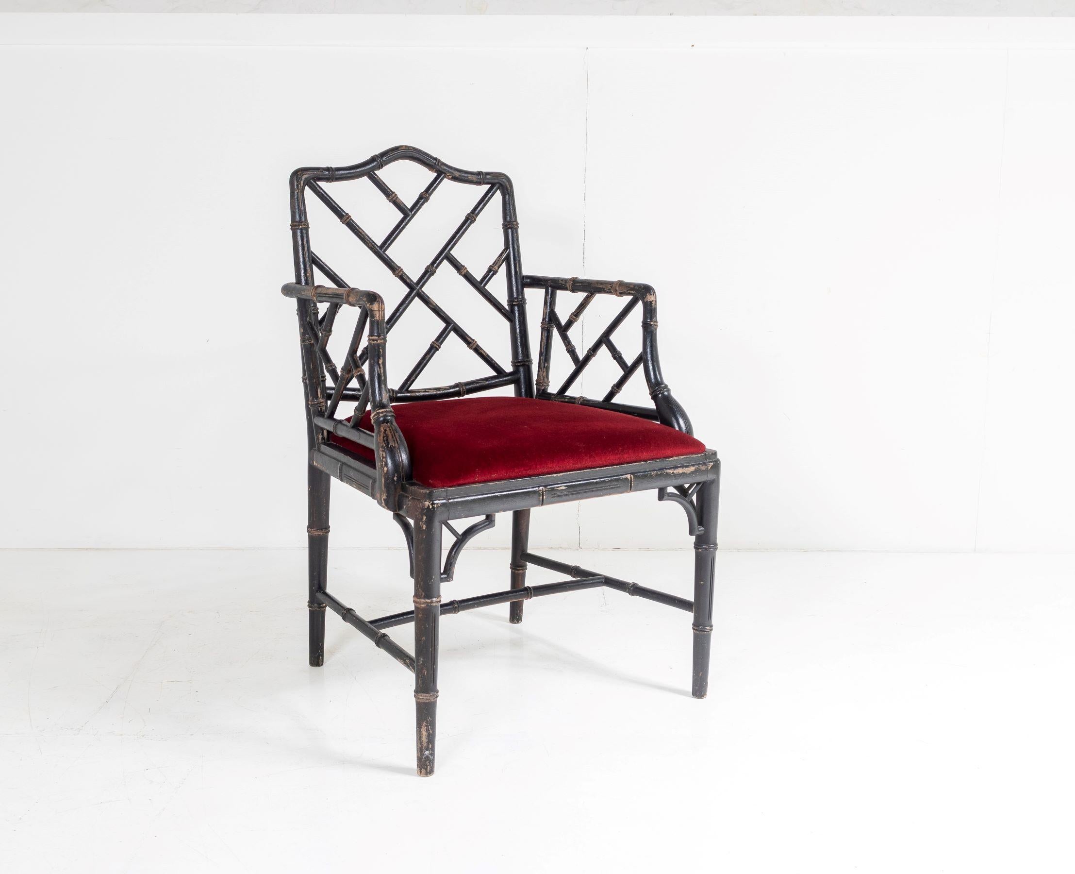 A charming faux bamboo Chinese Chippendale style chair in a distressed ebonised finish with deep red velvet fabric seat.
A lovely individual chair of good character, this 1970s example is of good quality and has a great decorative charm with worn