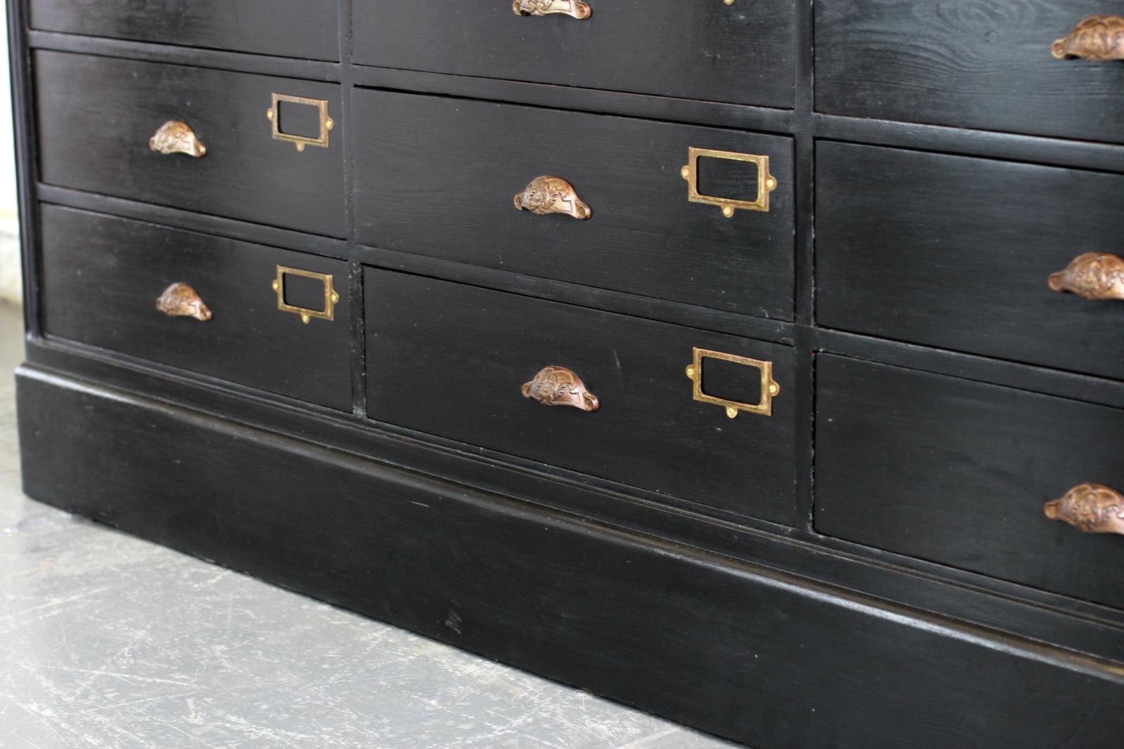 Ebonised French Apothecary drawers, circa 1910

- Solid pine drawers
- Ornate cast iron handles and brass card holders
- Oak top
- Pine Panel sides
- 9 identical large drawers
- French, circa 1910
- Measures: 185cm long x 56cm deep x 77cm