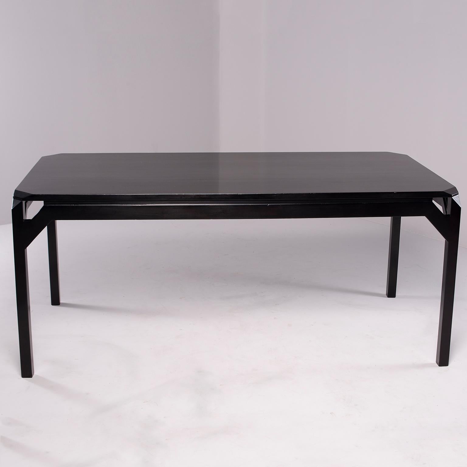 Found in England, this circa 1970 beech table has a new, professionally applied ebonized finish. Unique open work detail at each corner formed by apron. Apron clearance height is 26.75” high. No leaves. Excellent vintage condition.
