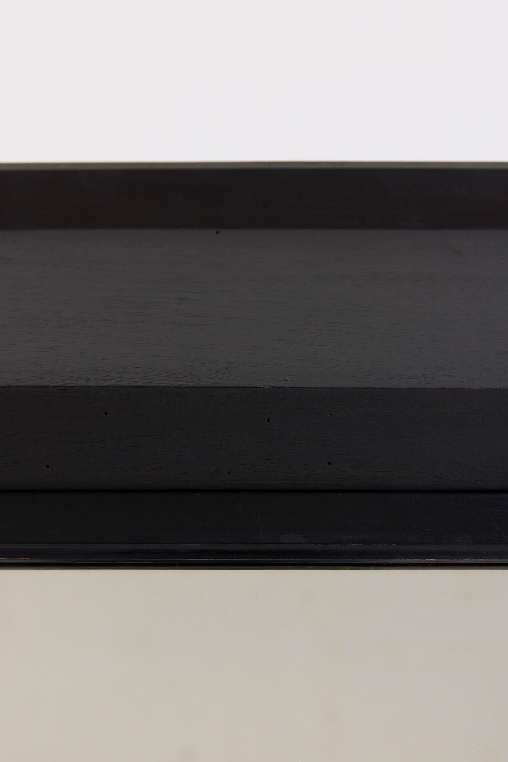 An ebonised geometric frame mirror
Spain, mid 20th Century
