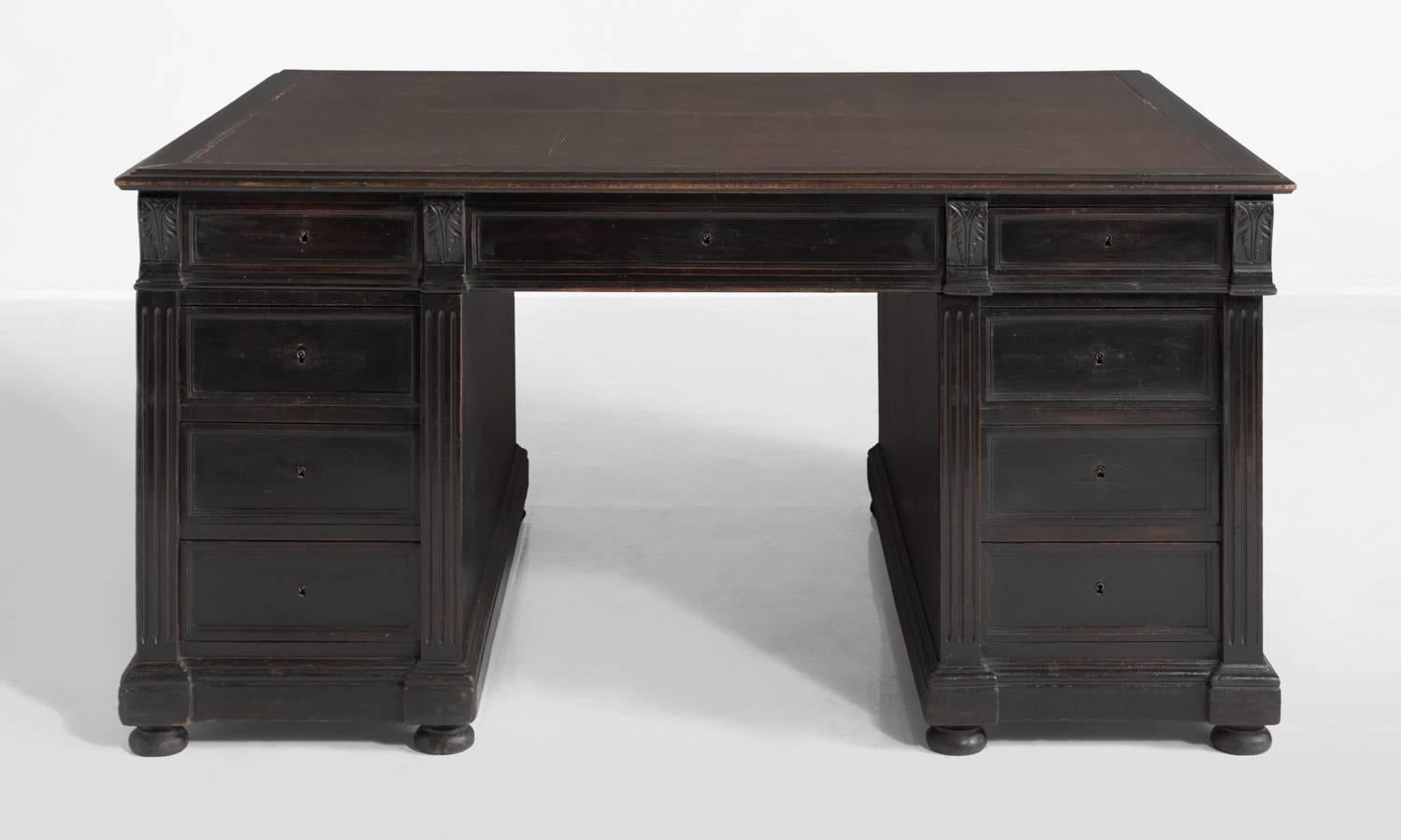 Ebonised partner’s desk, circa 1890.

Original leather writing pad with pull-out top extensions on both sides and ornate detailing throughout.