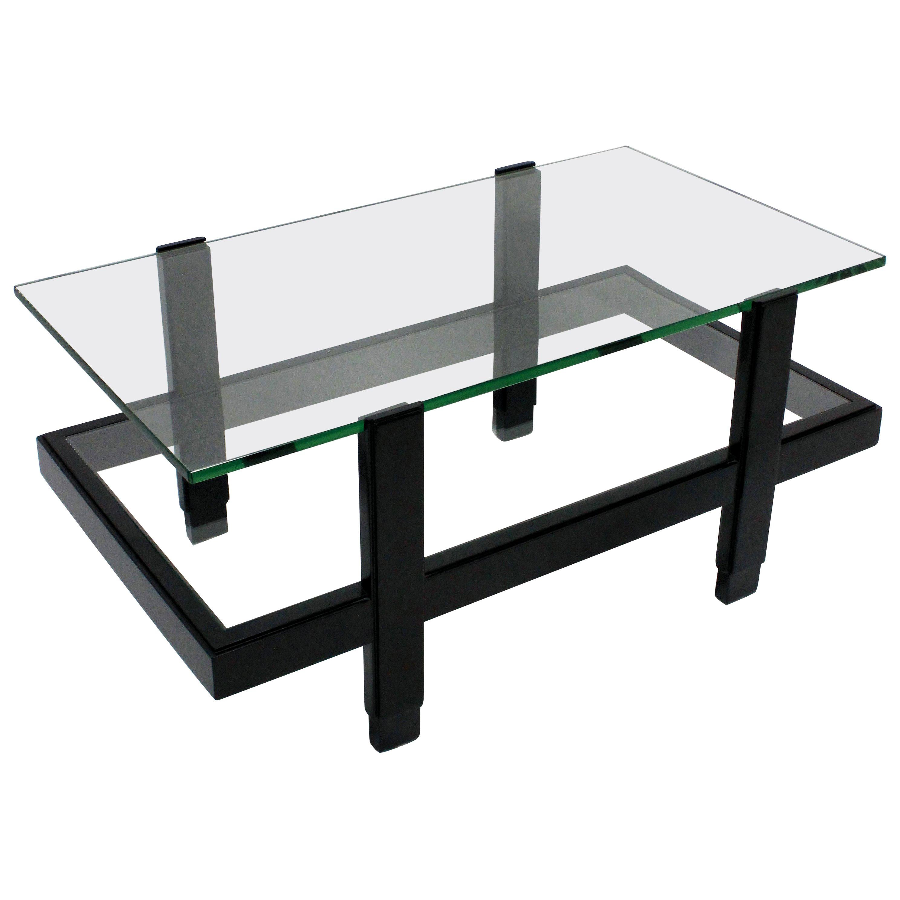 An Italian occasional table comprising two glazed tiers in black lacquered hardwood.