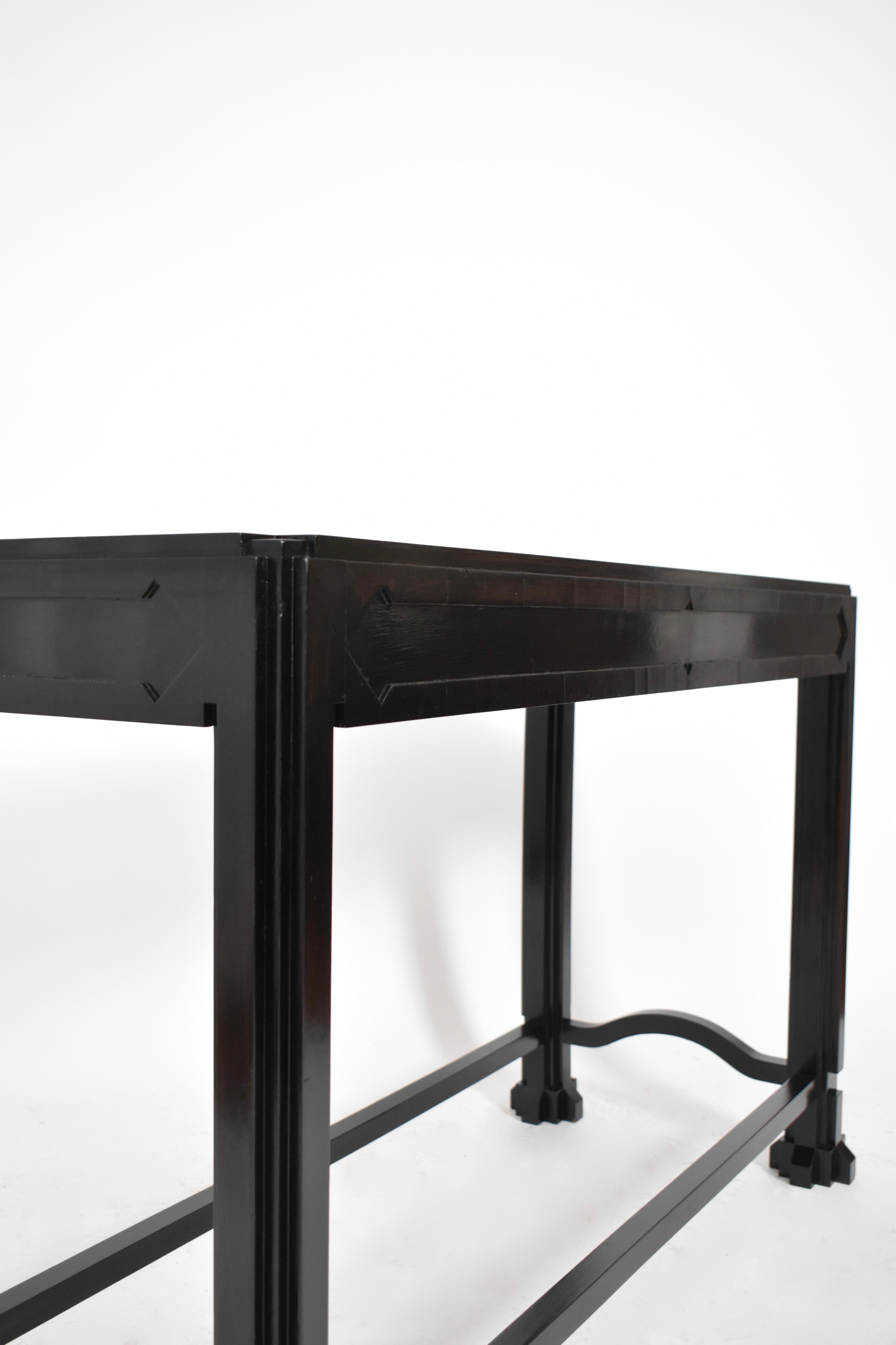 Ebonised wooden console table in with a rectangular top, relief decoration and geometrical reserves. Portugal, 1980s.